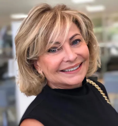 Medium Haircut with Warm Highlights and Bangs