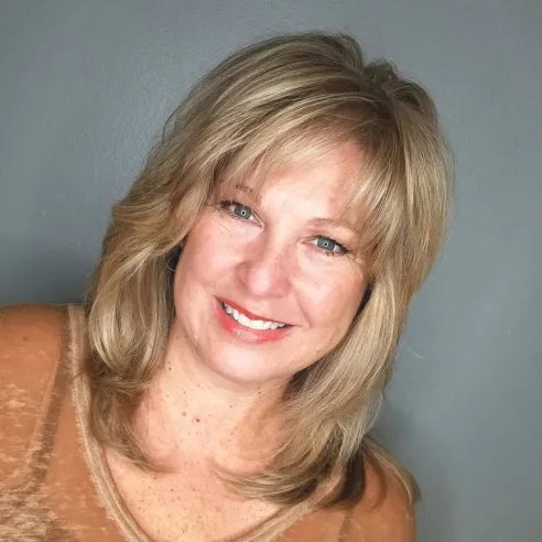 Medium Layered Haircut with Wispy Bangs