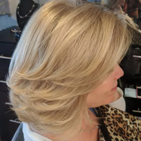 Medium Strawberry Blonde Hairstyle with Swoopy Layers