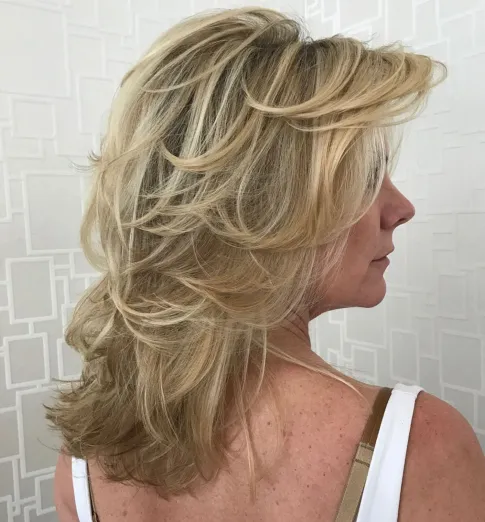 Mid Length Feathered Beige Blonde Hairstyle
