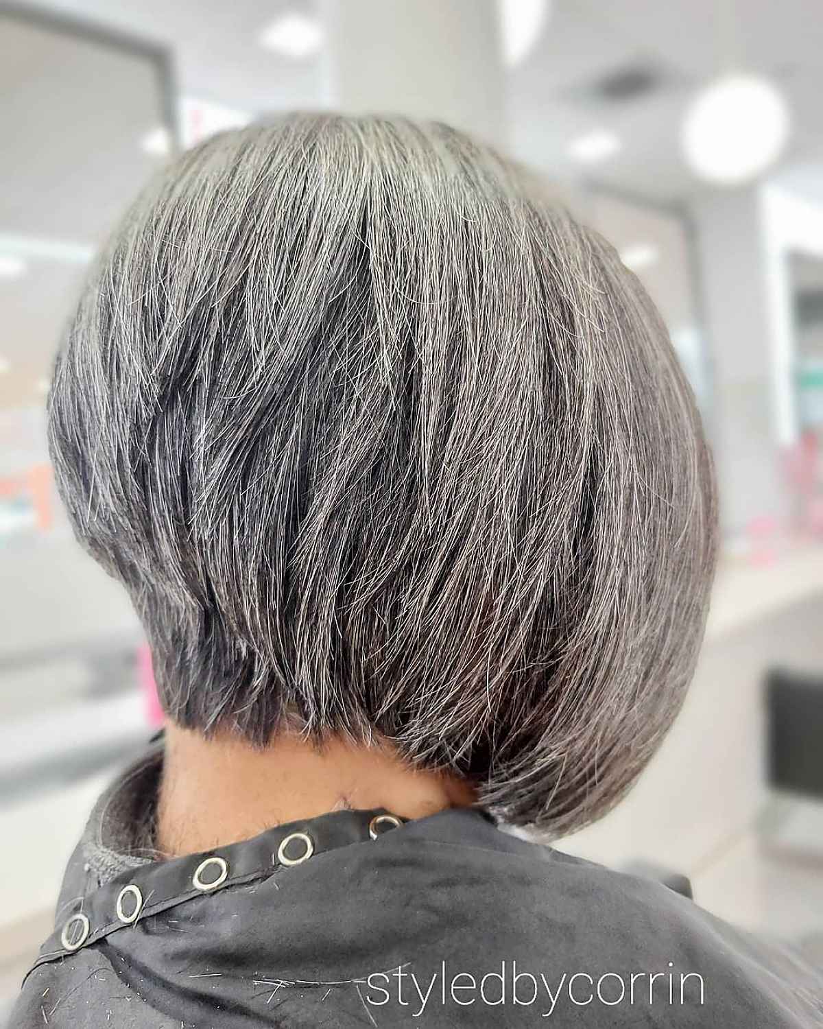 a woman over 60 with a salt and pepper wedge haircut
