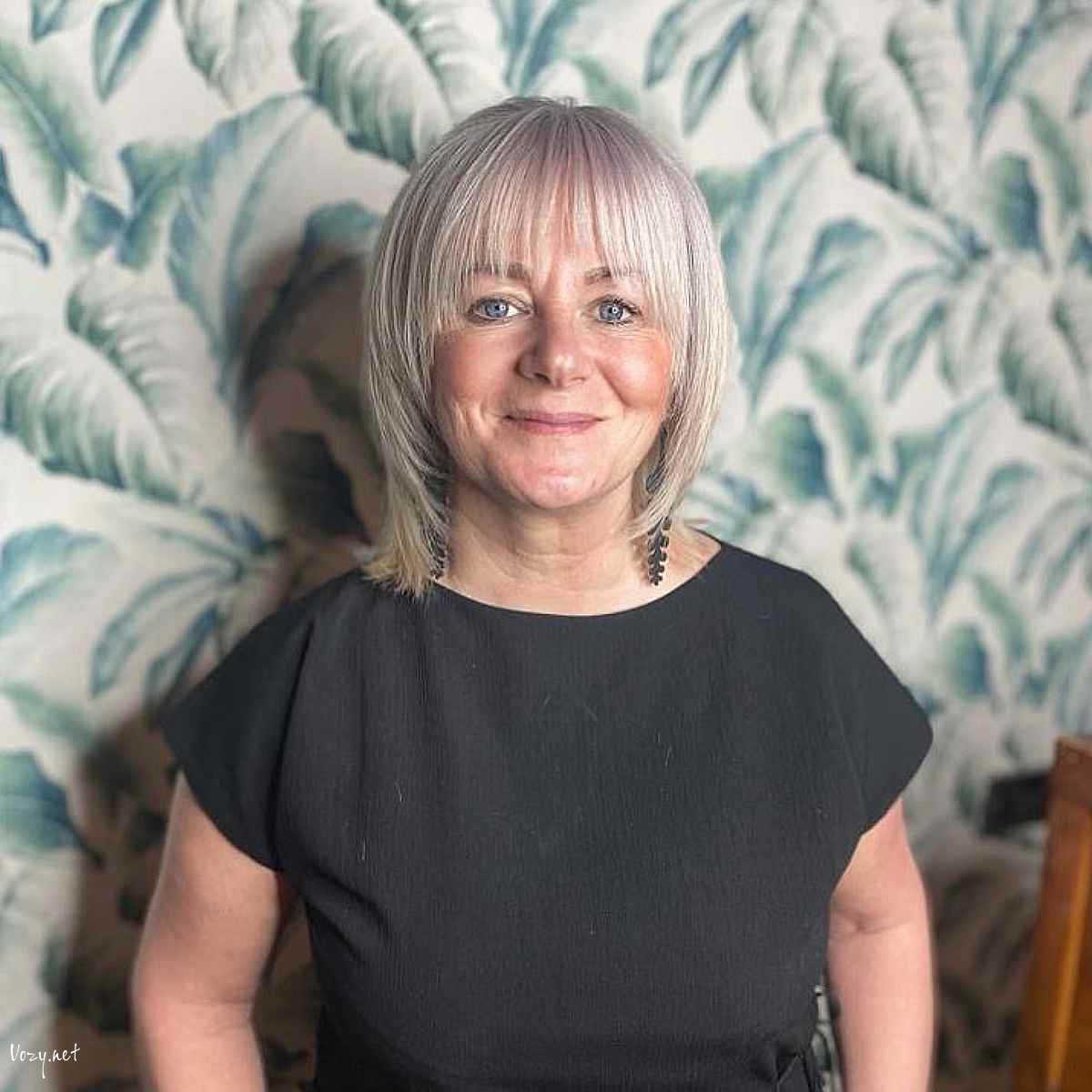 ash blonde lob with face framing layers and bangs for women over fifty