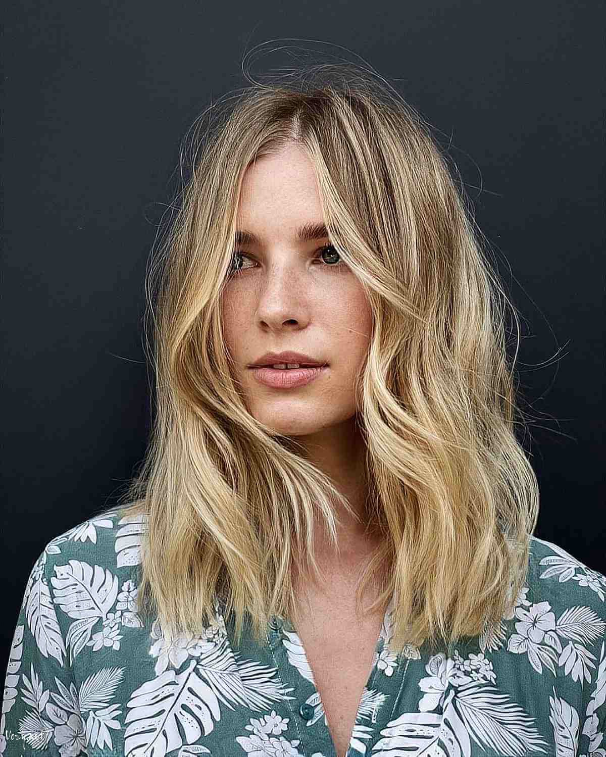 blonde shaggy haircut with a center part for fine hair