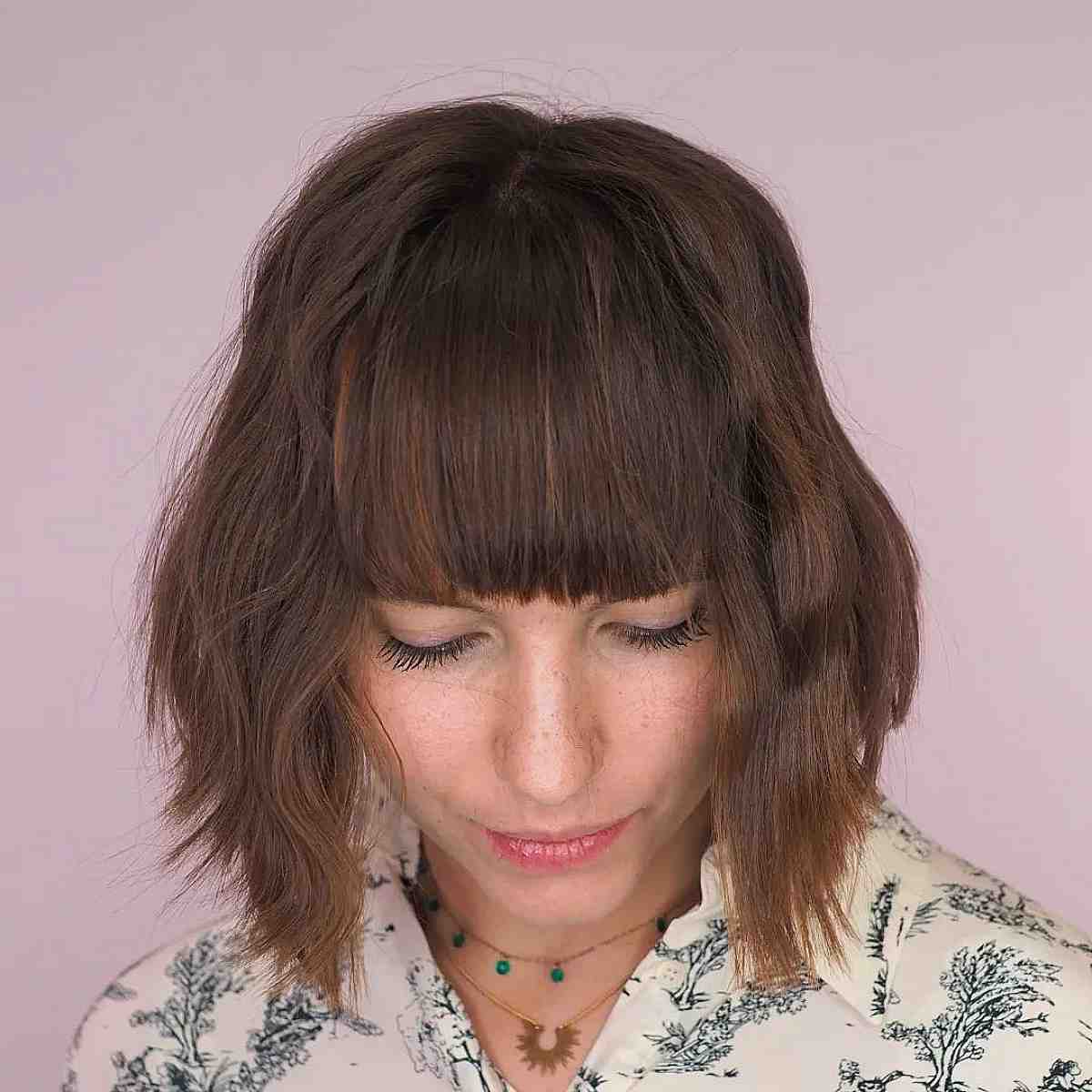 blunt inverted bob with textured ends and bangs