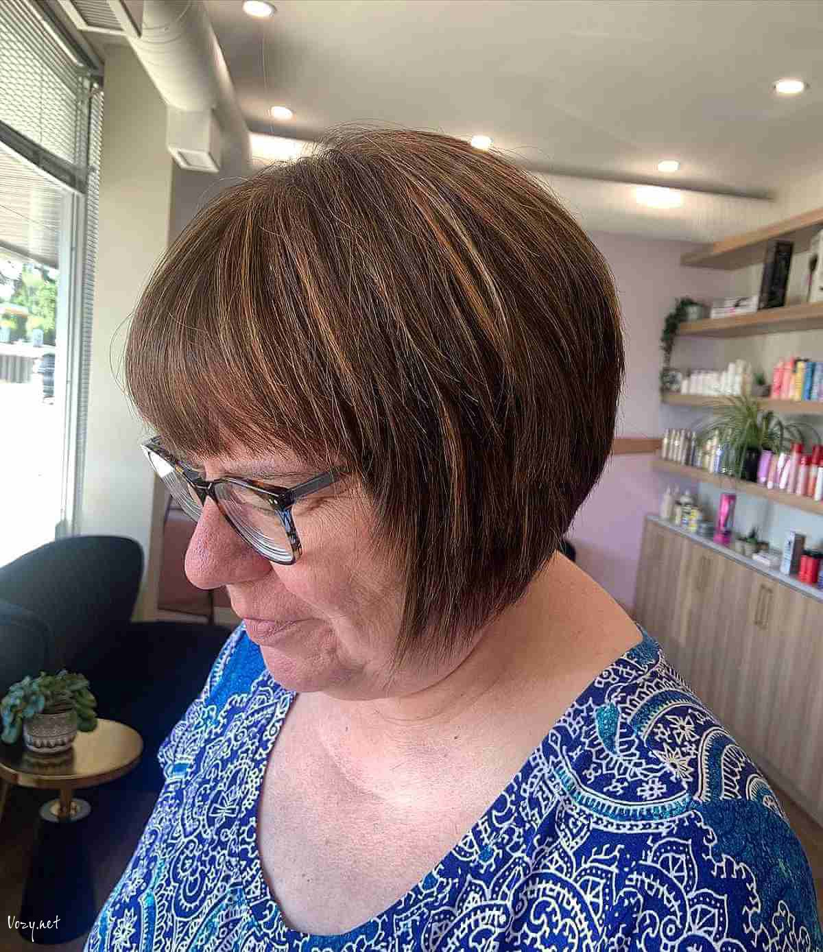brunette stacked bob with highlights for a lady in her 50s
