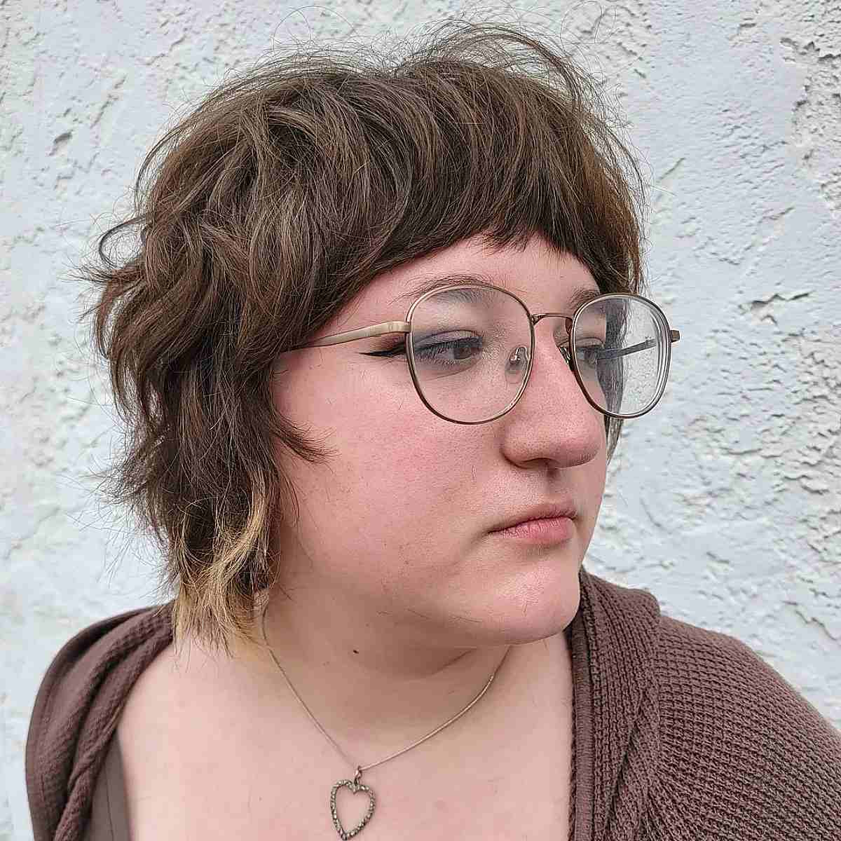 chin length multi layered bob with mini bangs on shaggy wavy hair