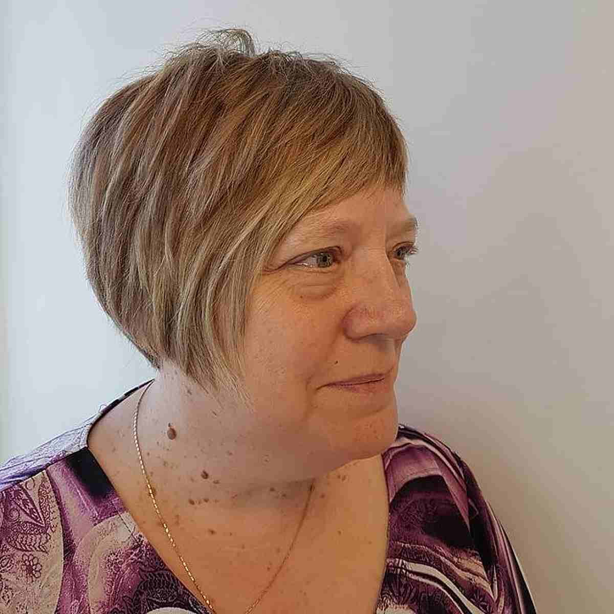 choppy pixie bob with short bangs for a 50 year old woman
