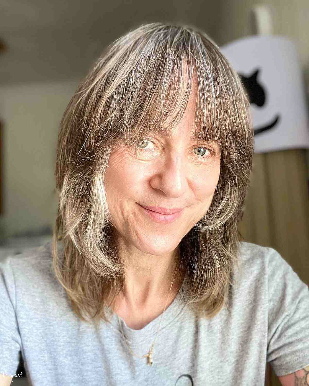 collarbone length razored shag with bangs for ladies over fifty