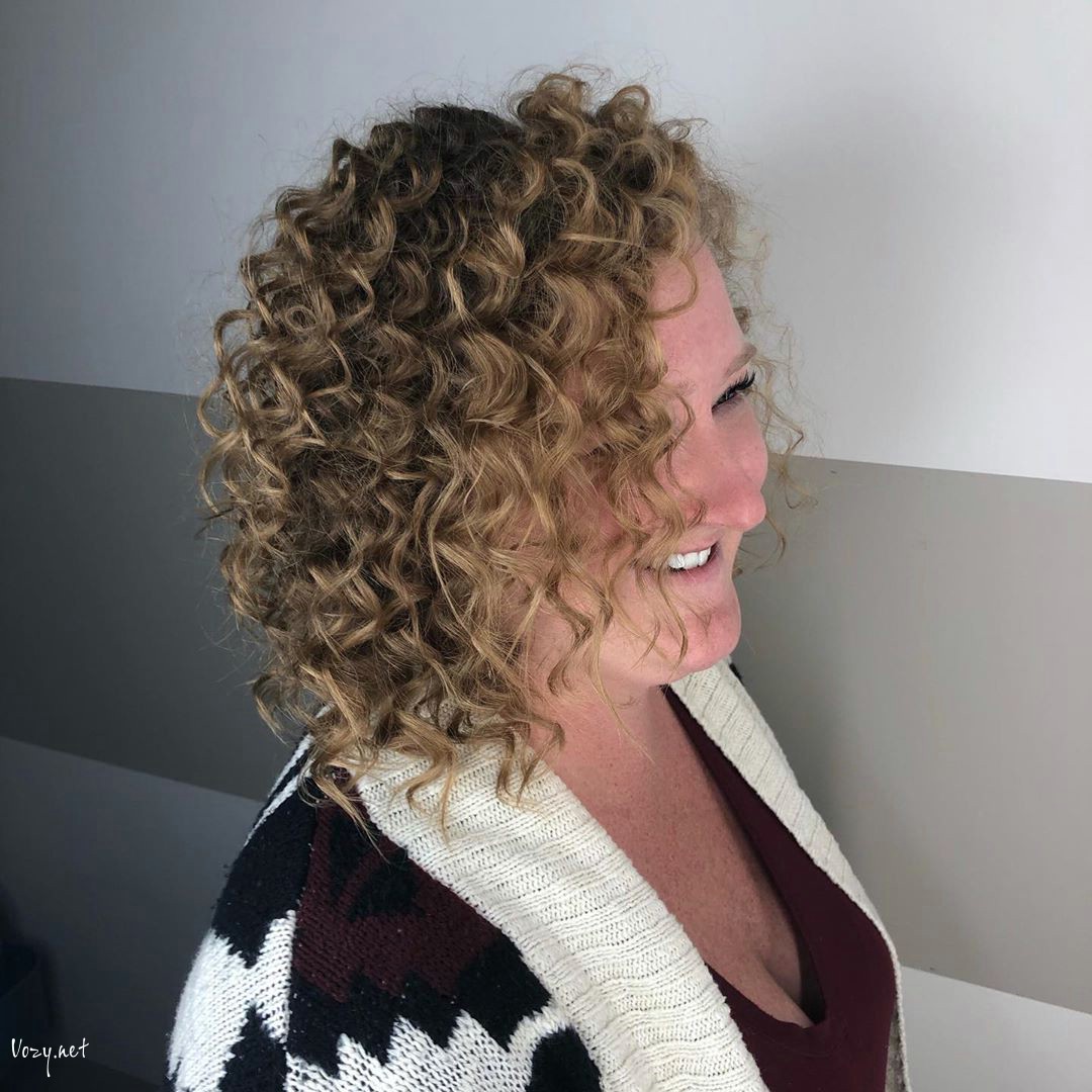 curly shoulder length hairstyle for women over 50 with round face