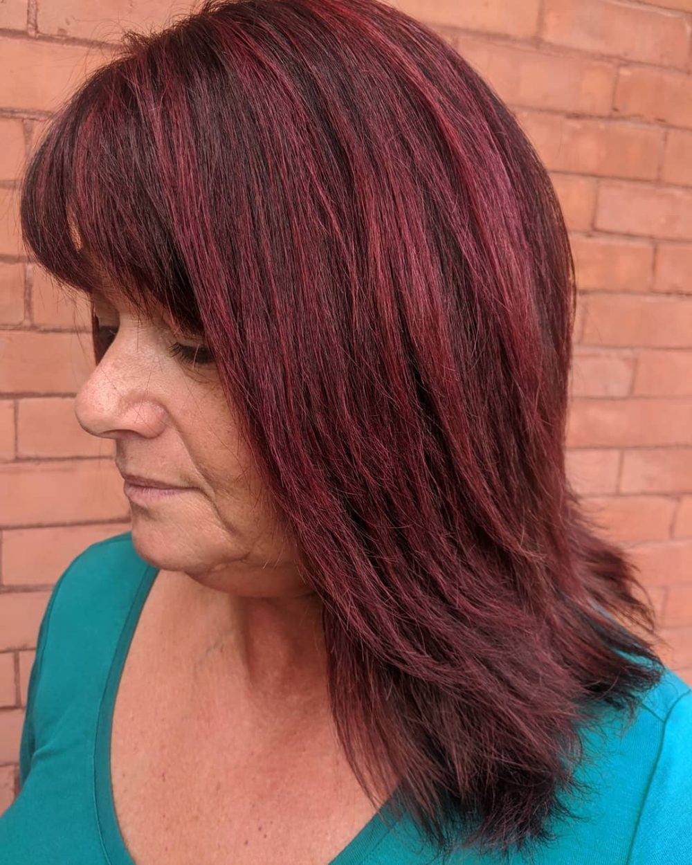 dark and vibrant burgundy balayage for ladies over 50