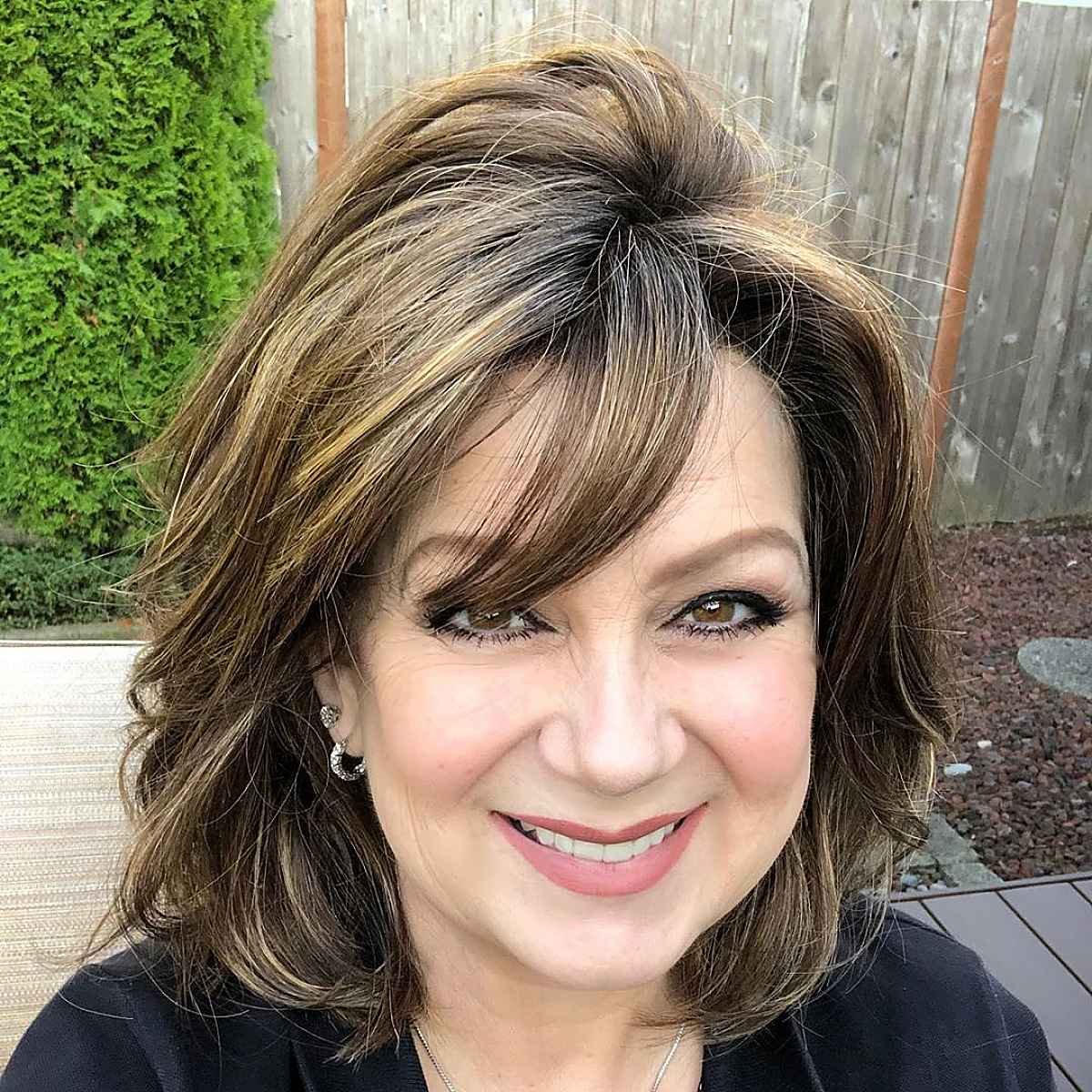 dark brunette with golden highlights fall hair color for older ladies
