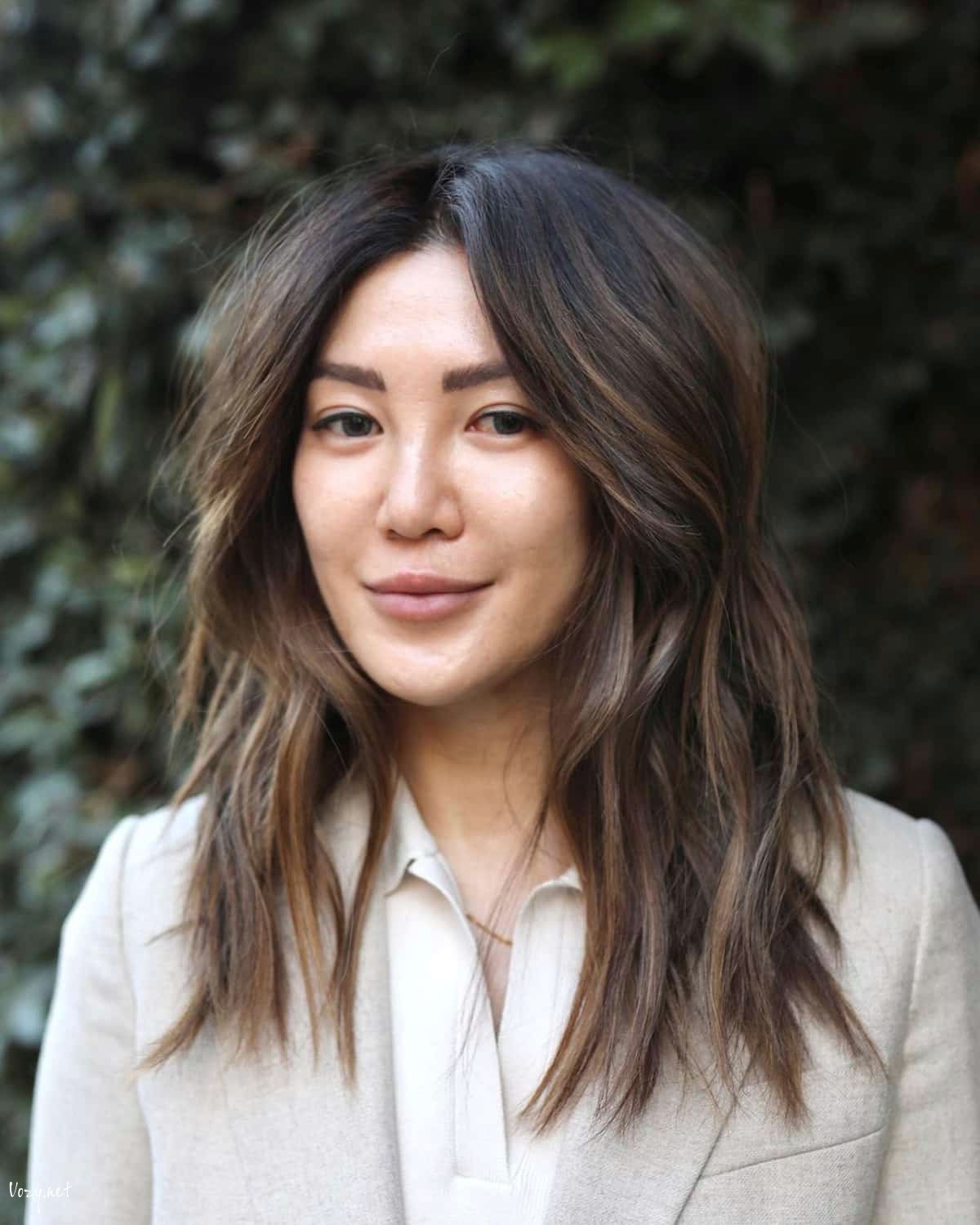 dark medium shaggy hairstyle with highlights