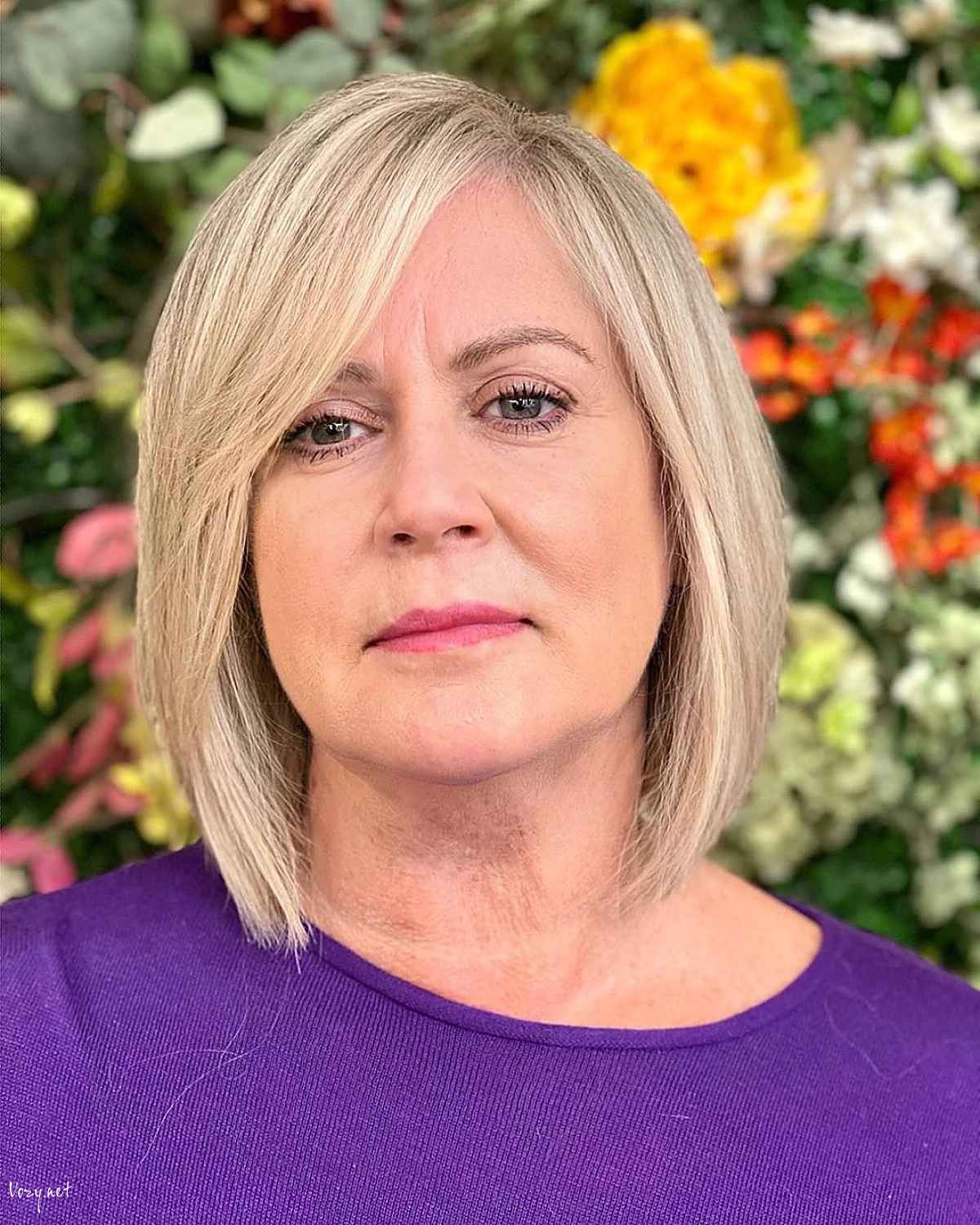 elegant bob cut with a side part and bangs for women over 50