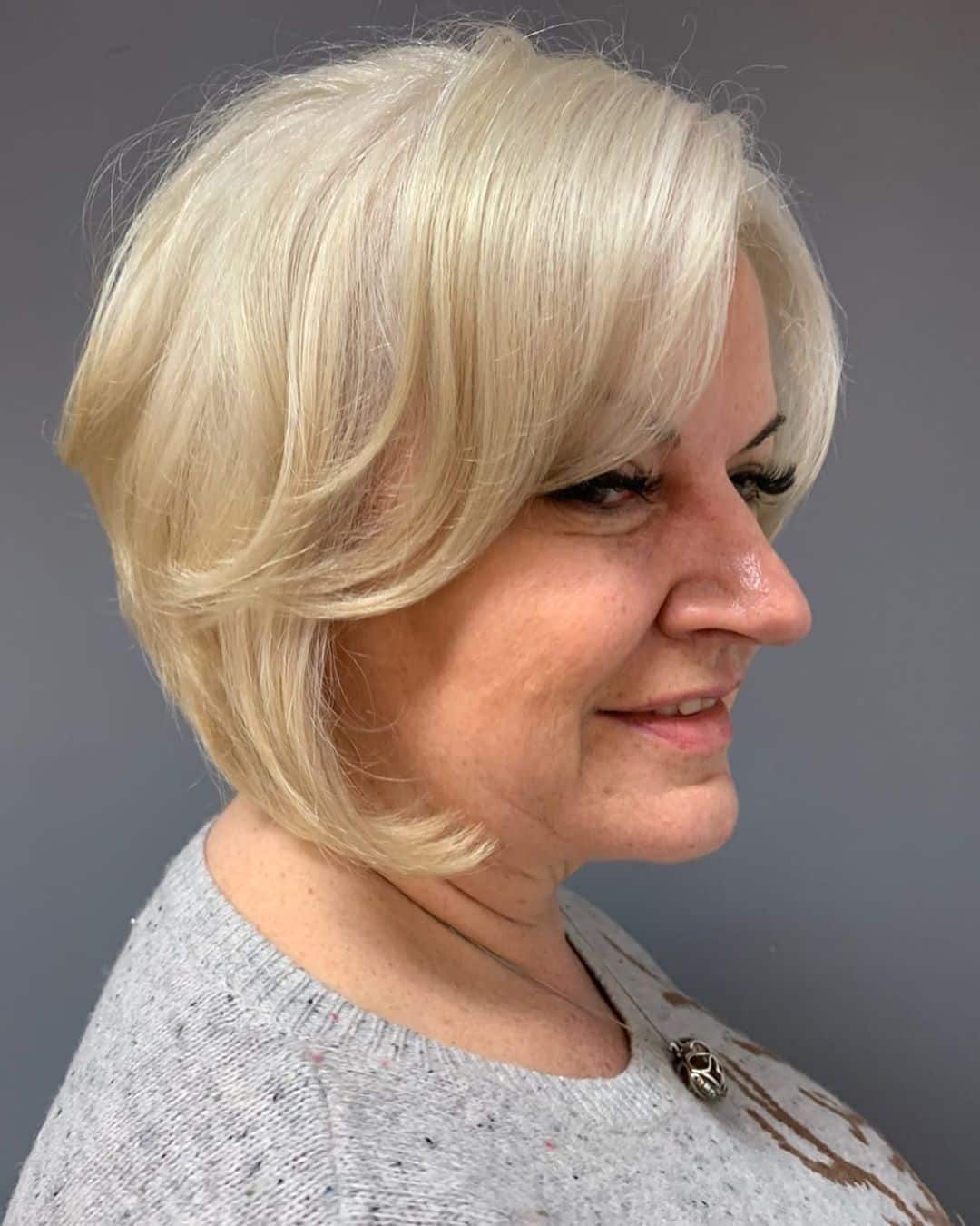 face framing inverted bob for women over 50 with round face