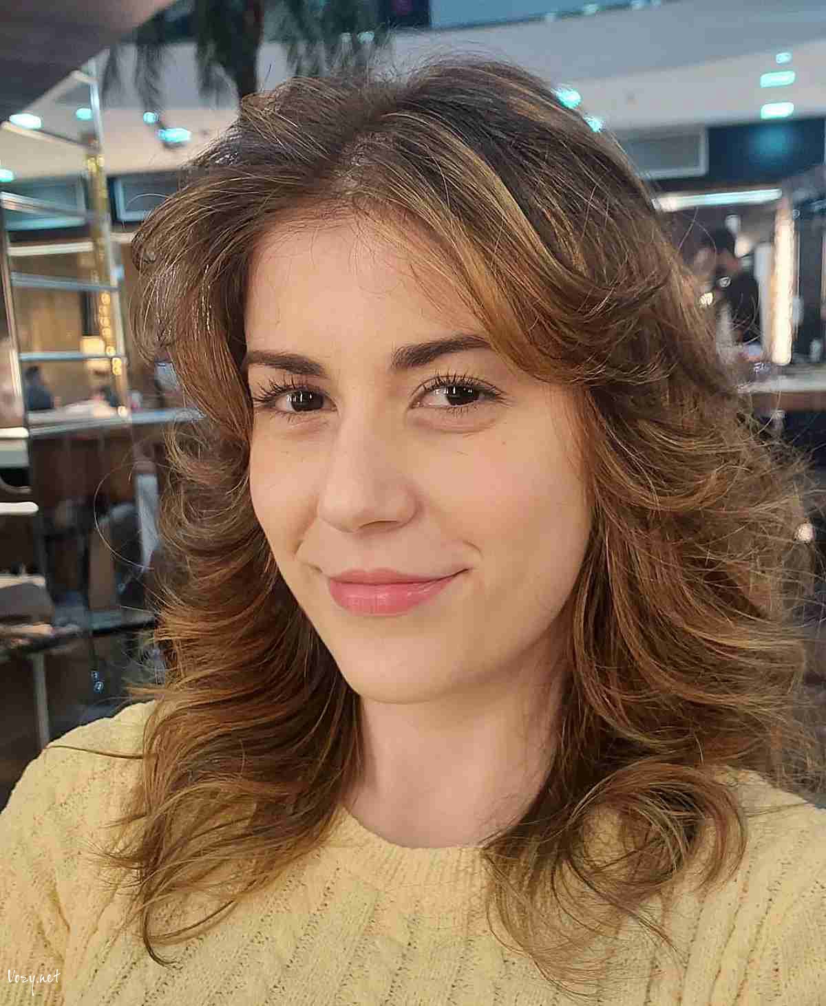 feathered layers and bangs on mid length wolf cut hair