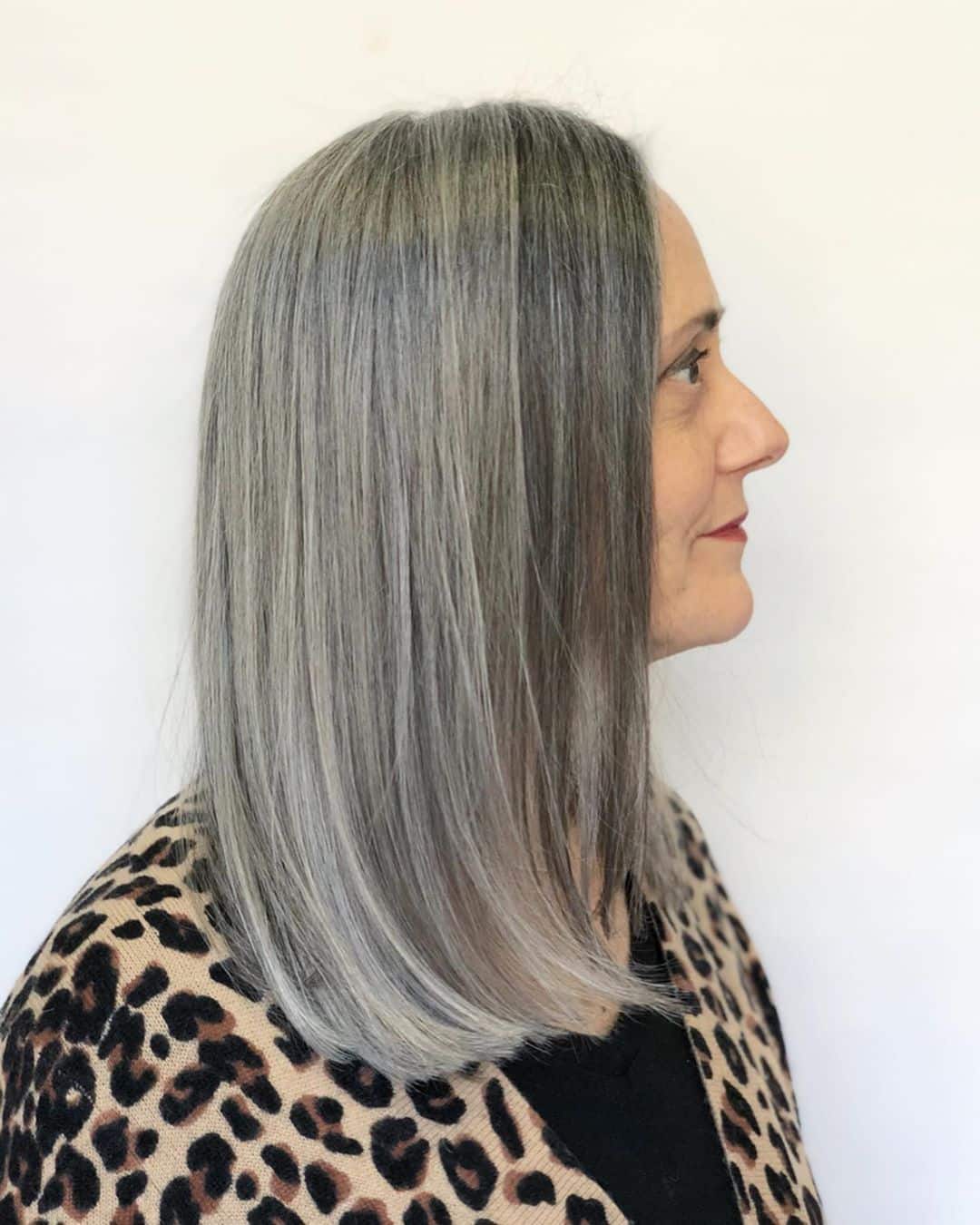 grey mid length lob for woman over 50 with a round face
