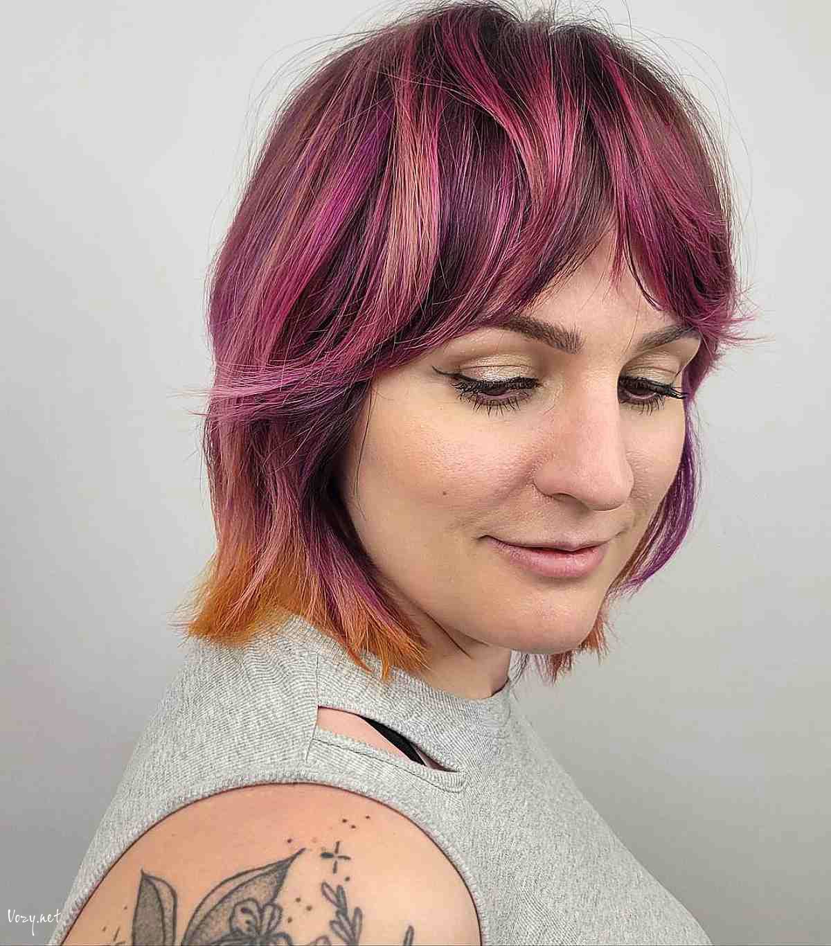 magenta wolf cut bob and curtain bangs