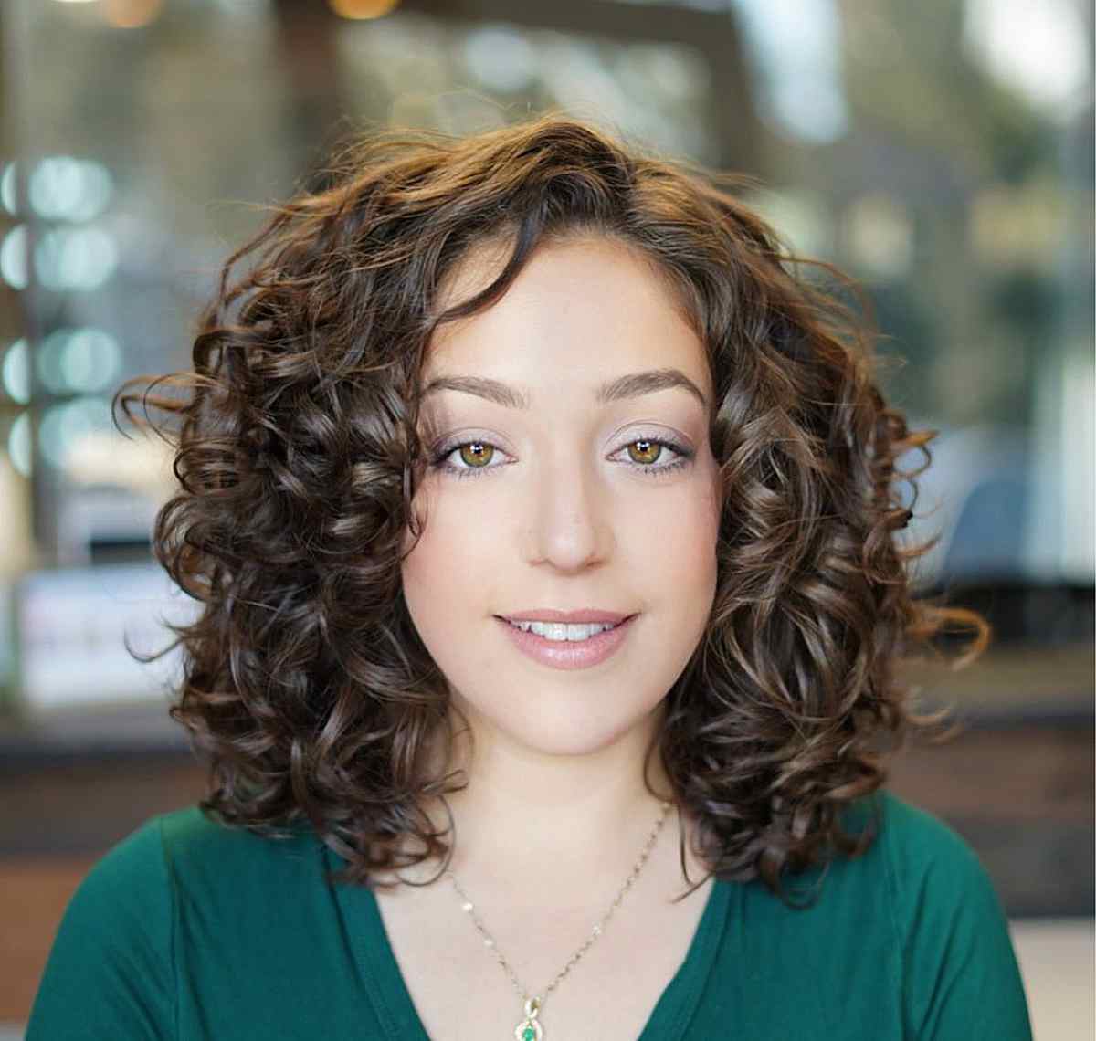 medium layered cut with fluffy curls for an oval face