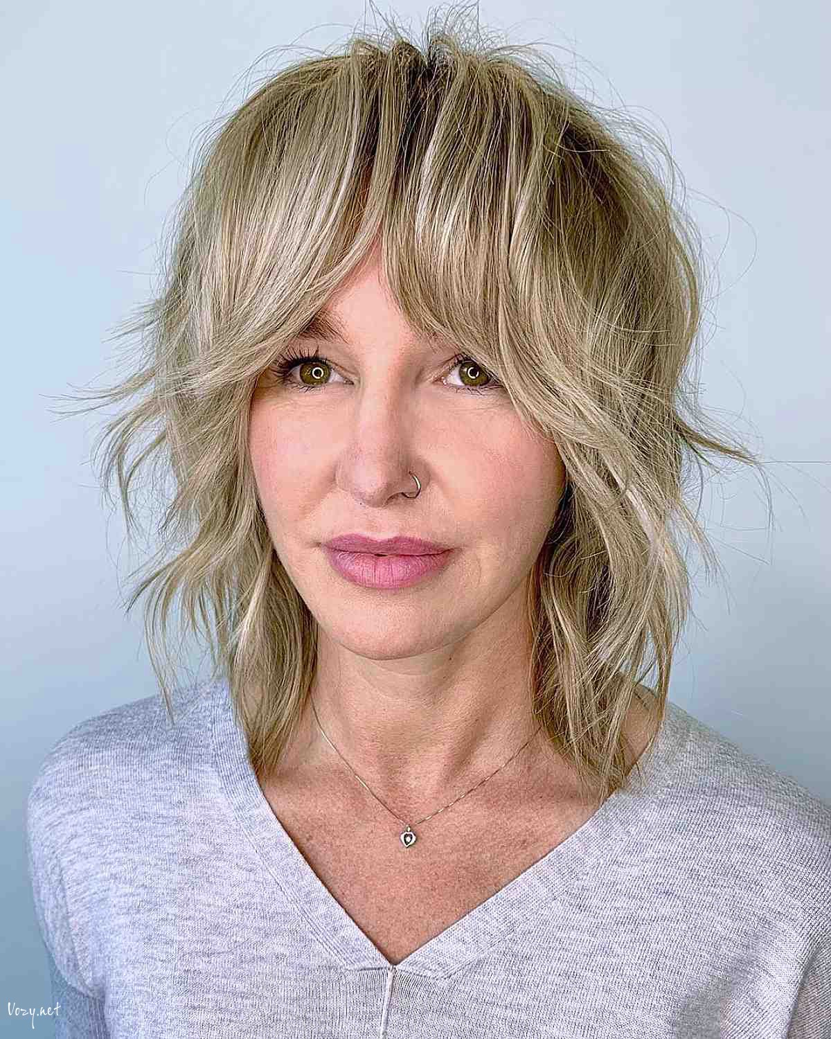 medium layered shag with blonde highlights and bangs