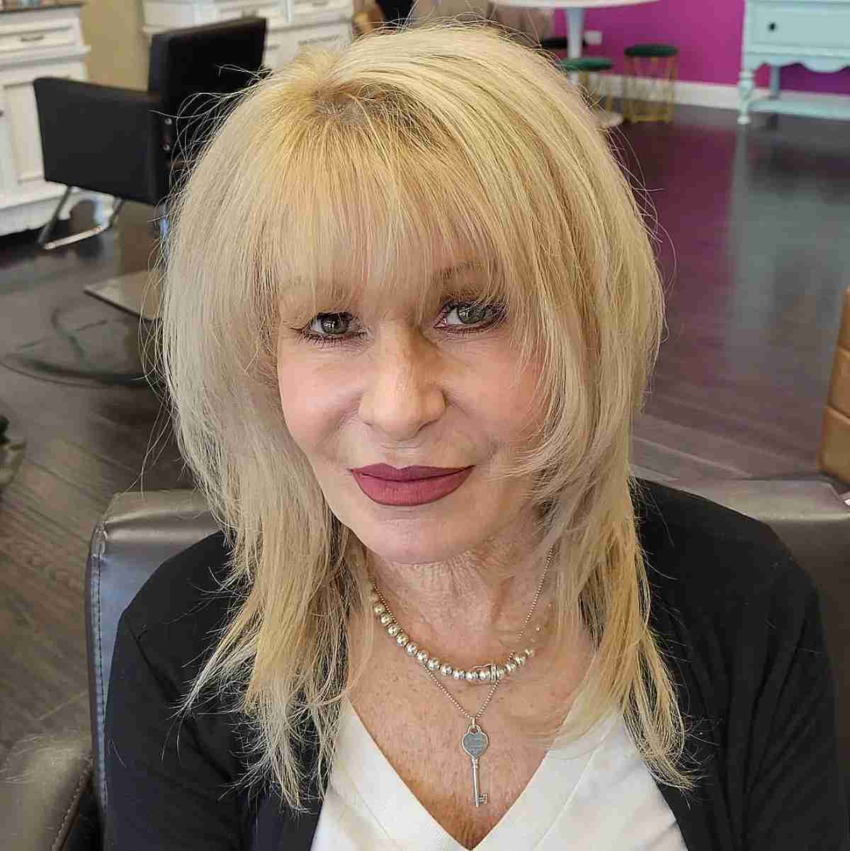 medium layered shag with wispy ends and bangs for ladies over seventy