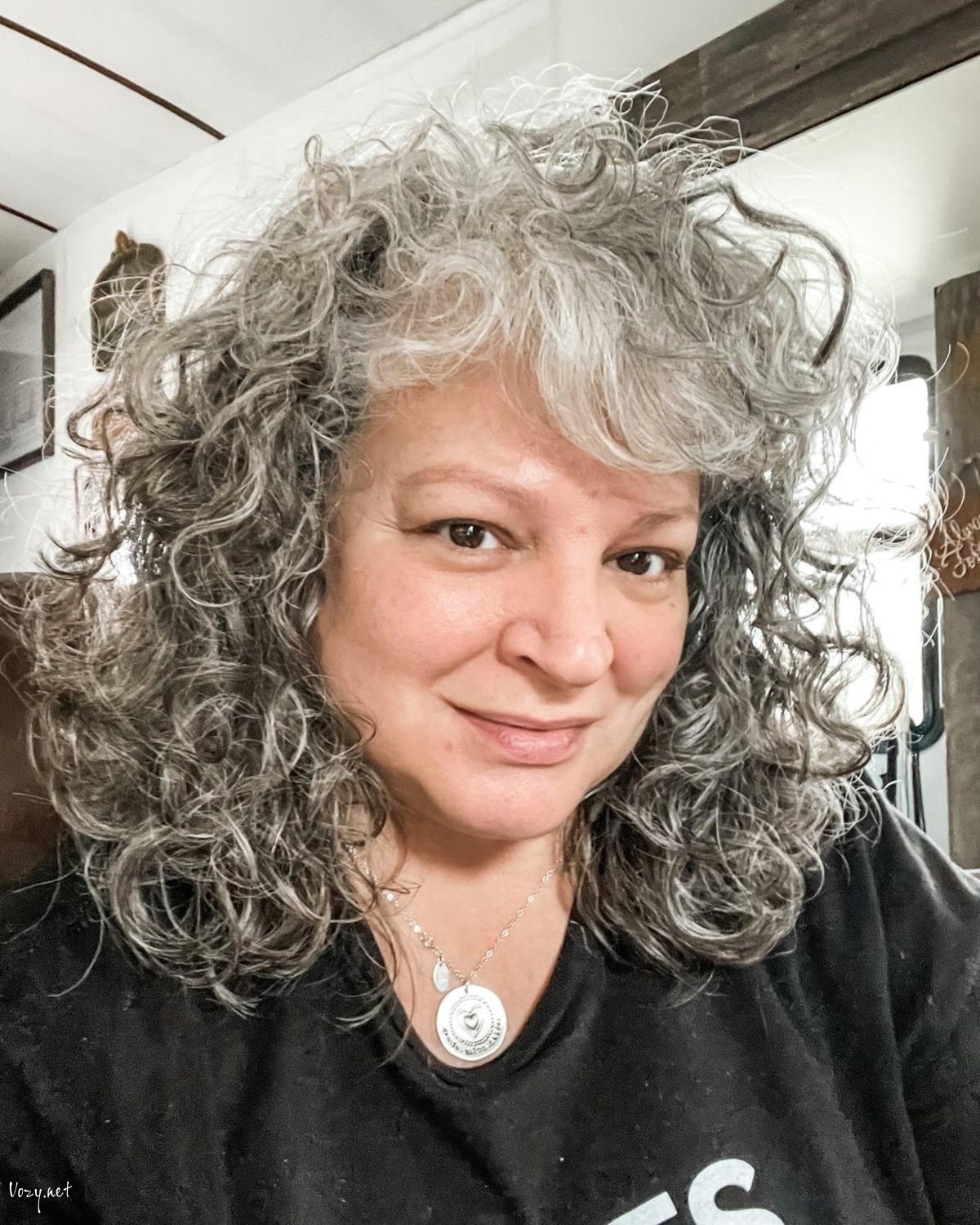 medium length cut for women in their fifties with curly hair