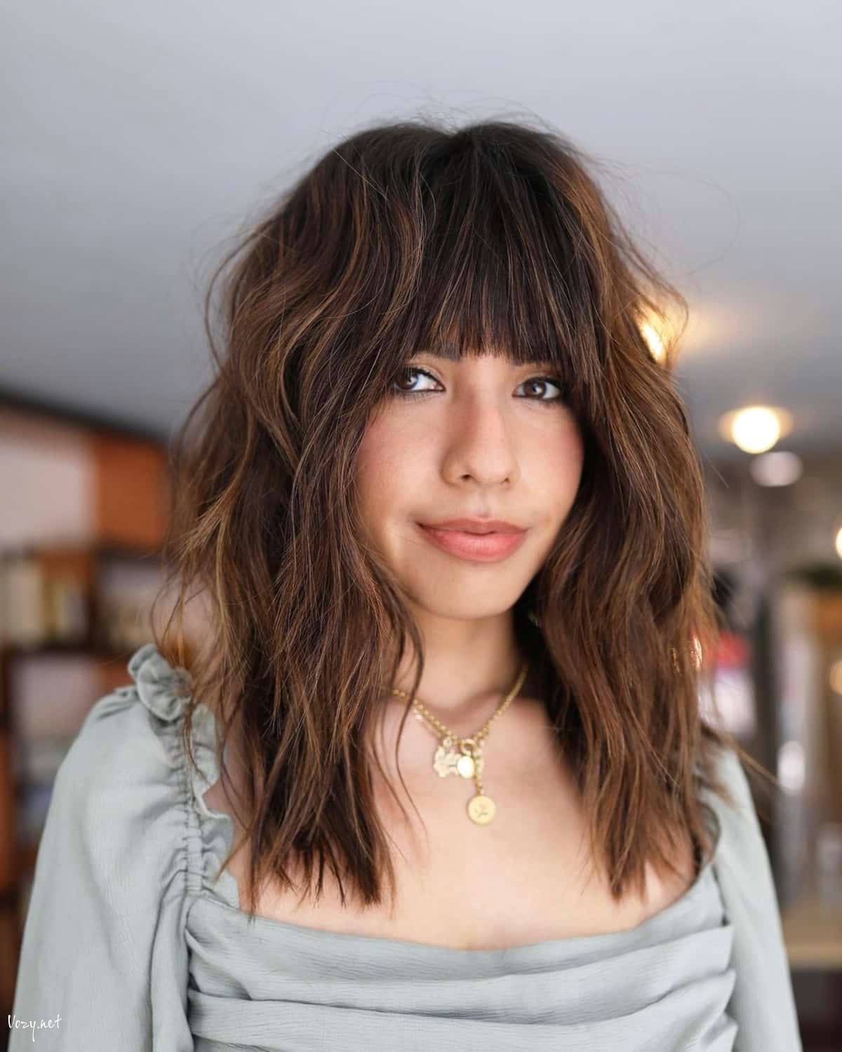 medium shag with bangs for oval faces 1