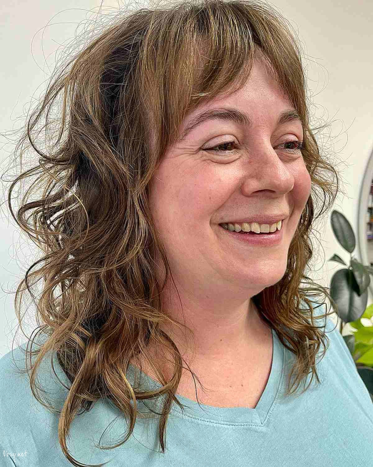 medium shaggy cut with loose curls for 50 year olds