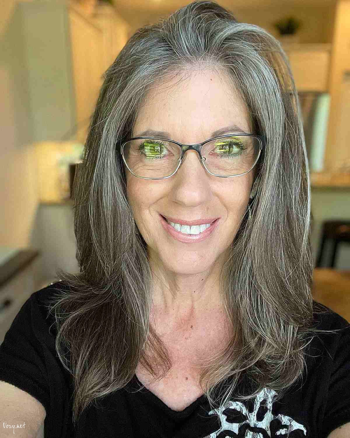 medium to long layered cut on grey haired women over fifty
