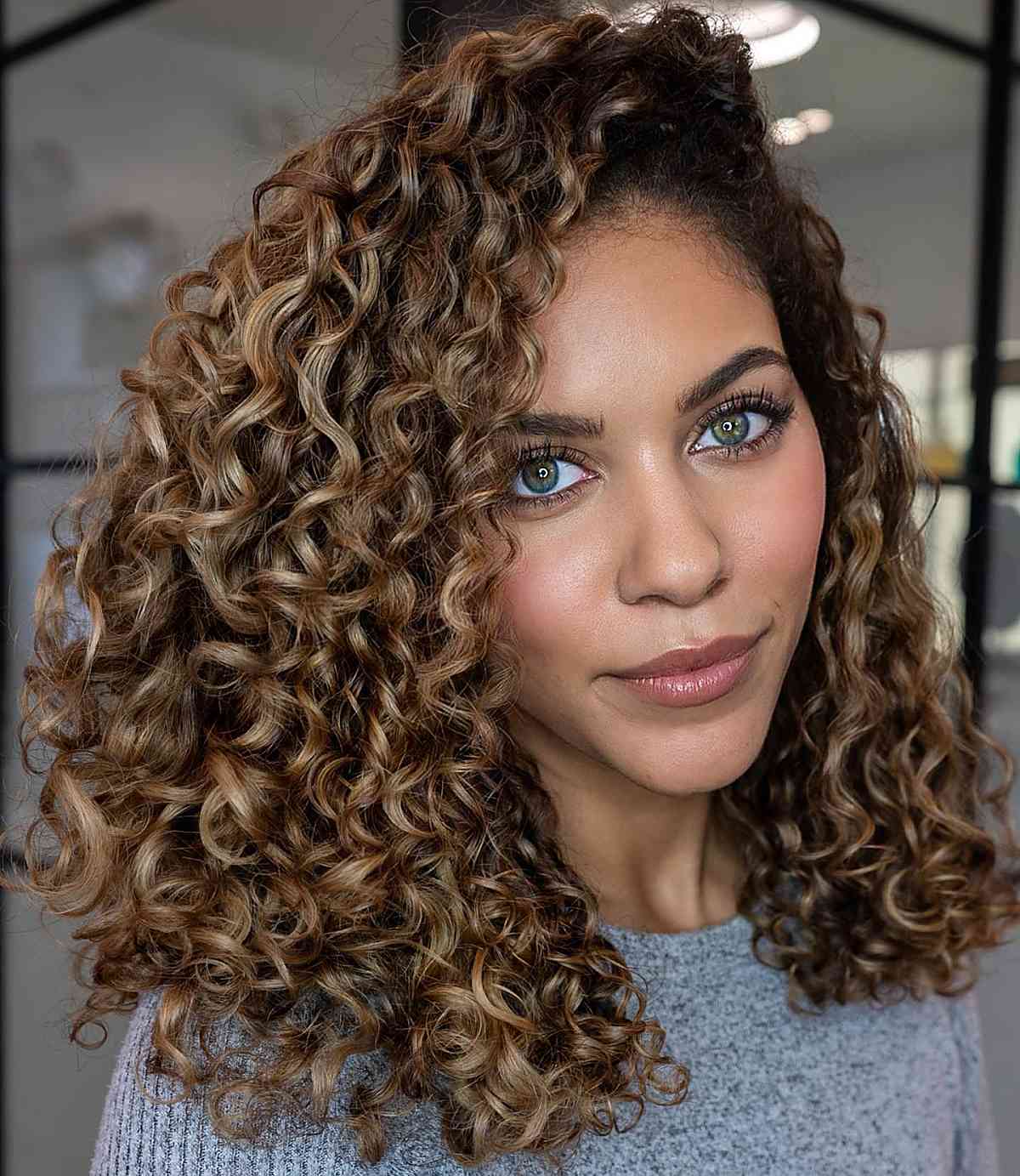 mid length blonde curls with a deep side part