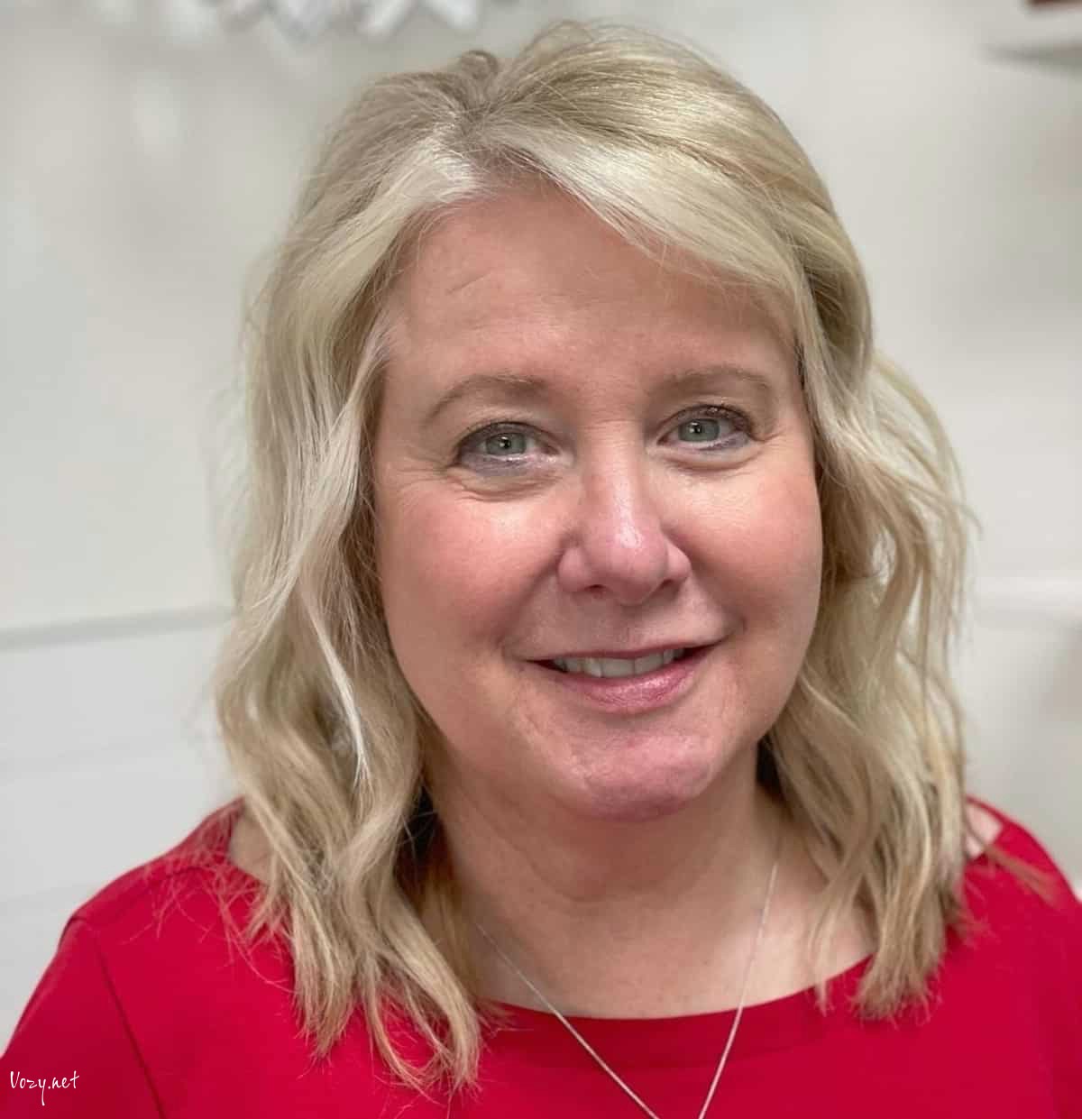 mid length layered bob for women in their 50s with a round face shape