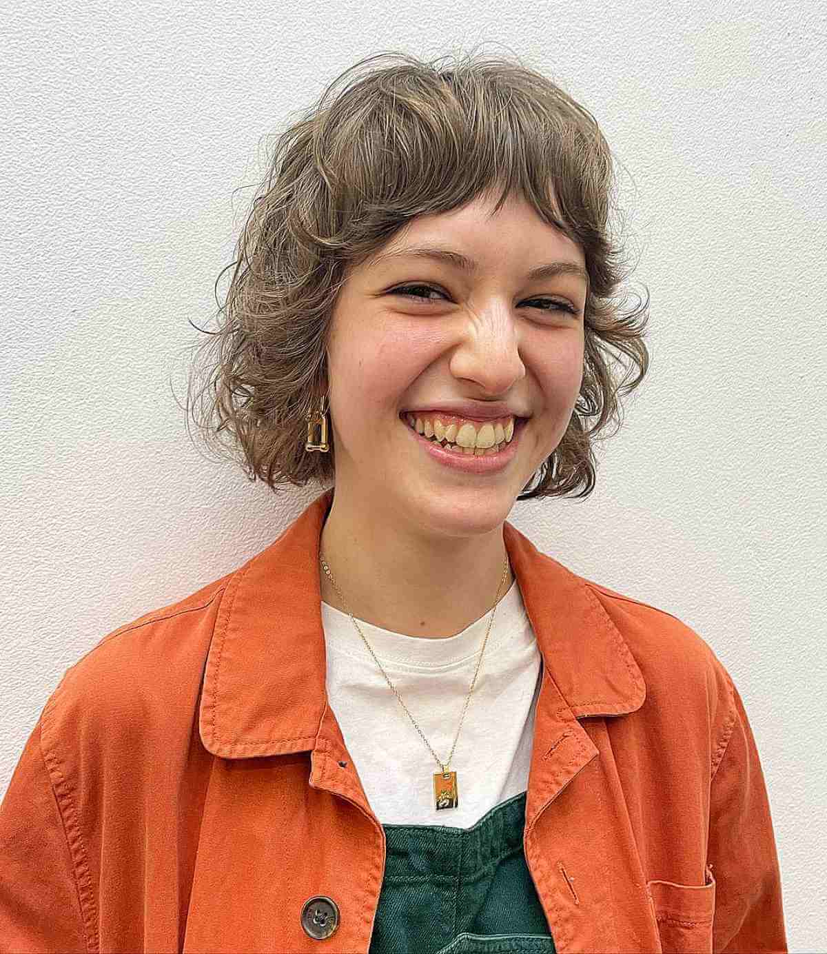 mini shag with feathered layers and bangs for oval face shapes