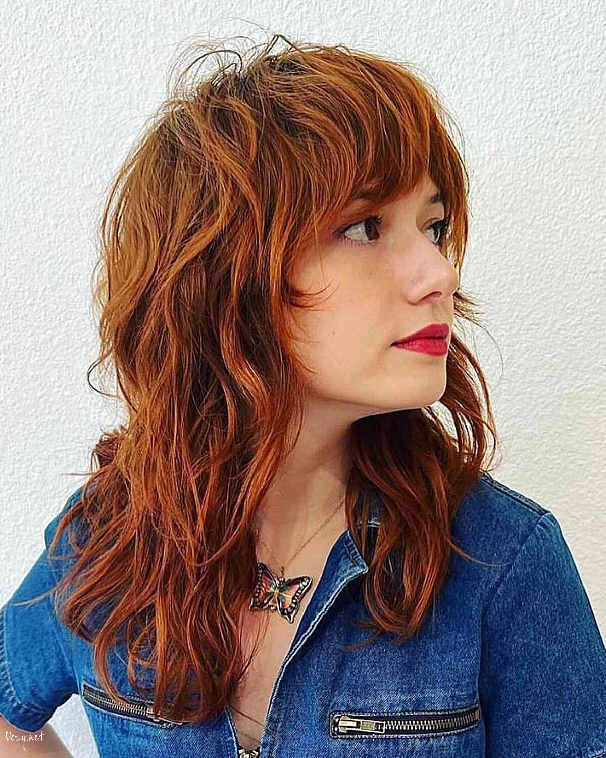 red shaggy wolf haircut with thick fringe