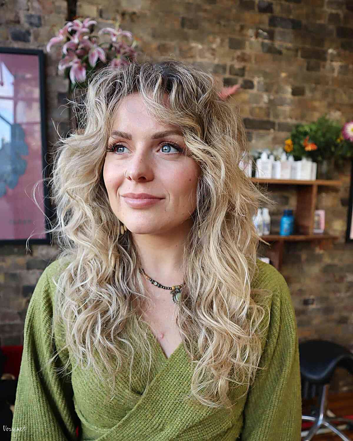 rooted blonde curly shag wolf cut