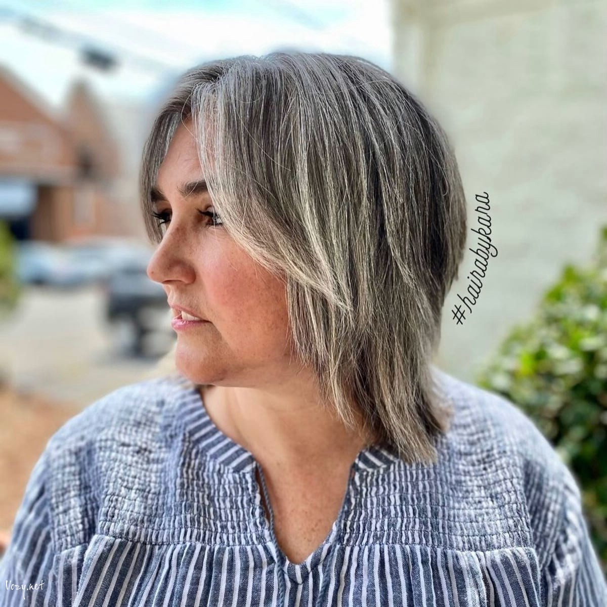 shaggy layered bob with curtain bangs for women over fifty