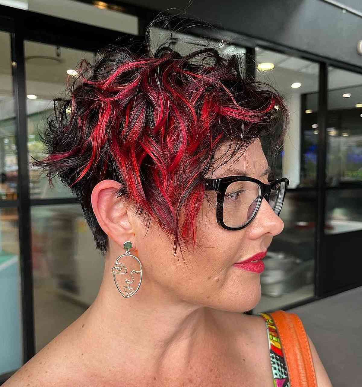 short asymmetric hair cut with bold red highlights