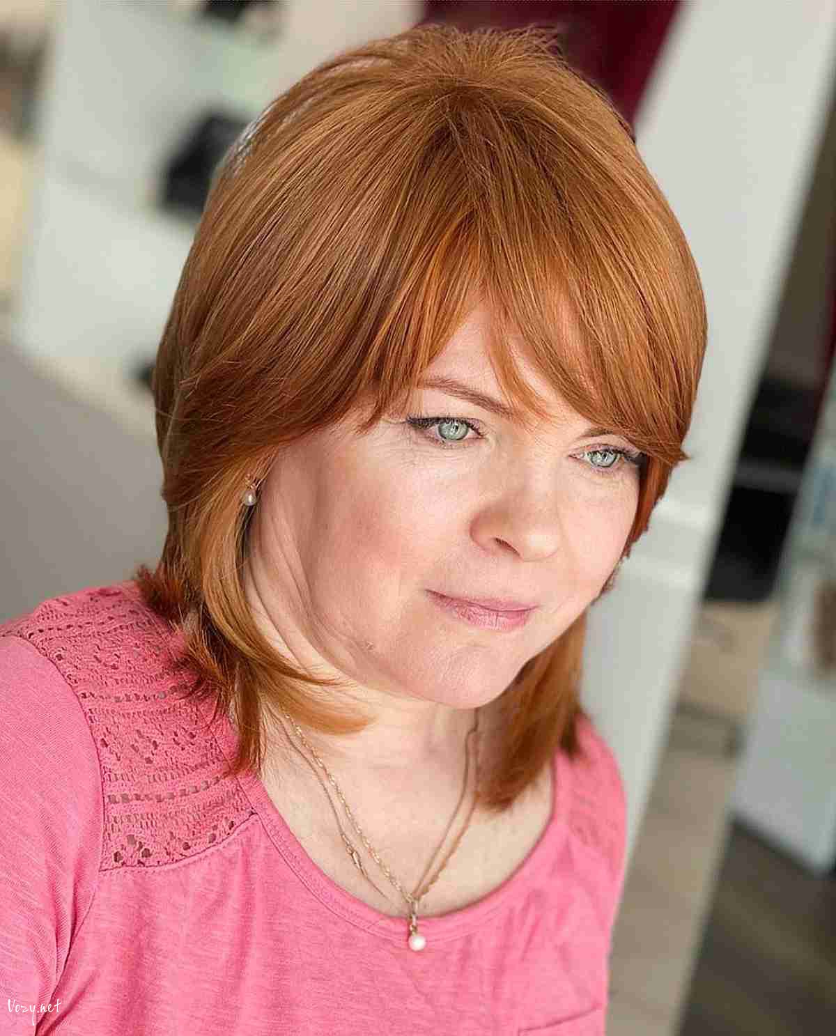 short copper cut with side swept bangs for ladies over fifty