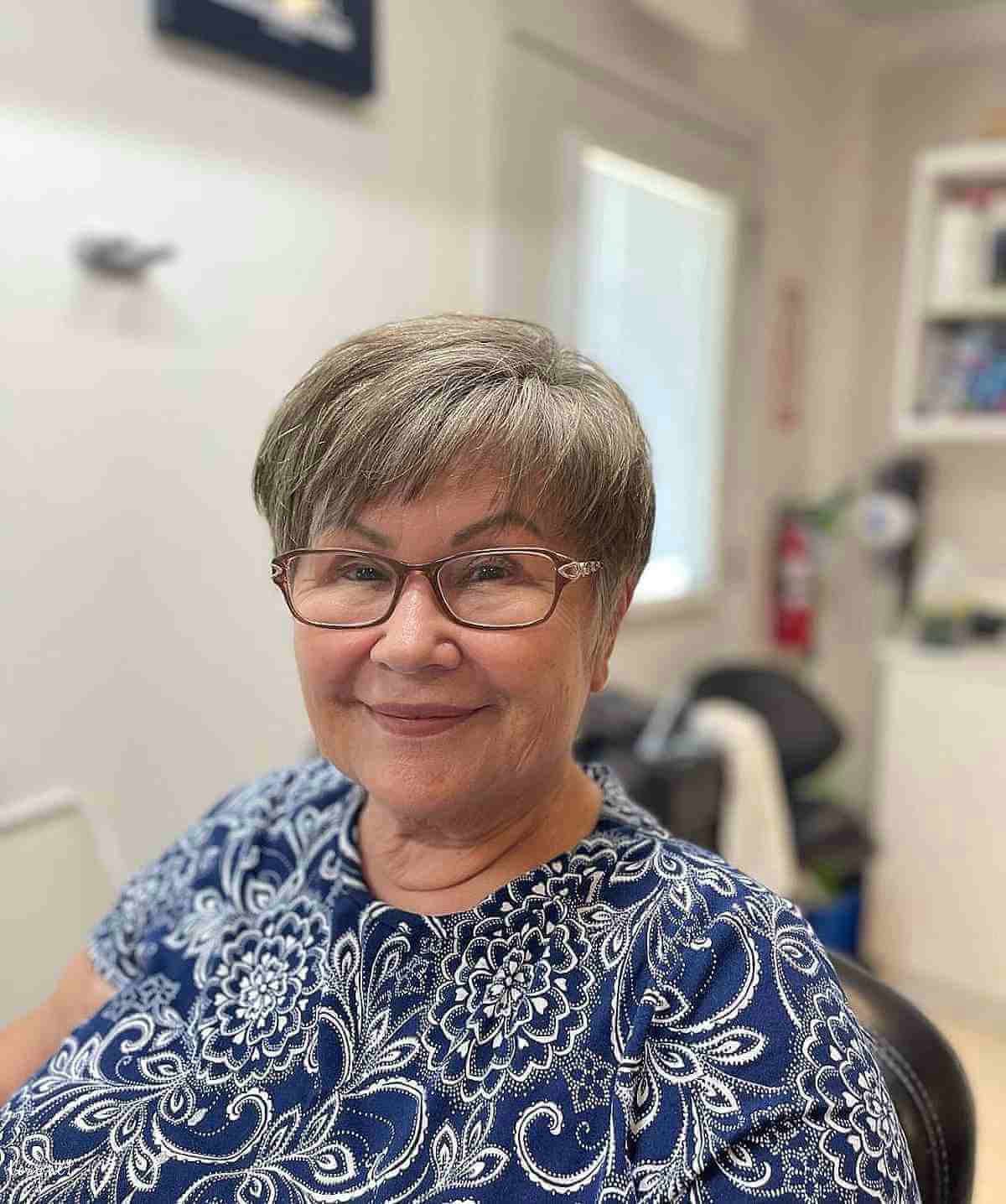 short grey hair with micro bangs for a woman in her 50s