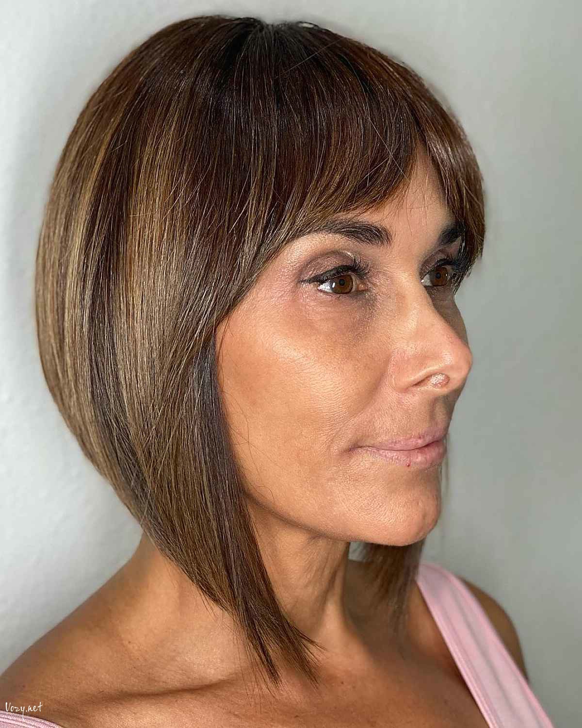 short layered hairstyle with curtain bangs for women over 40