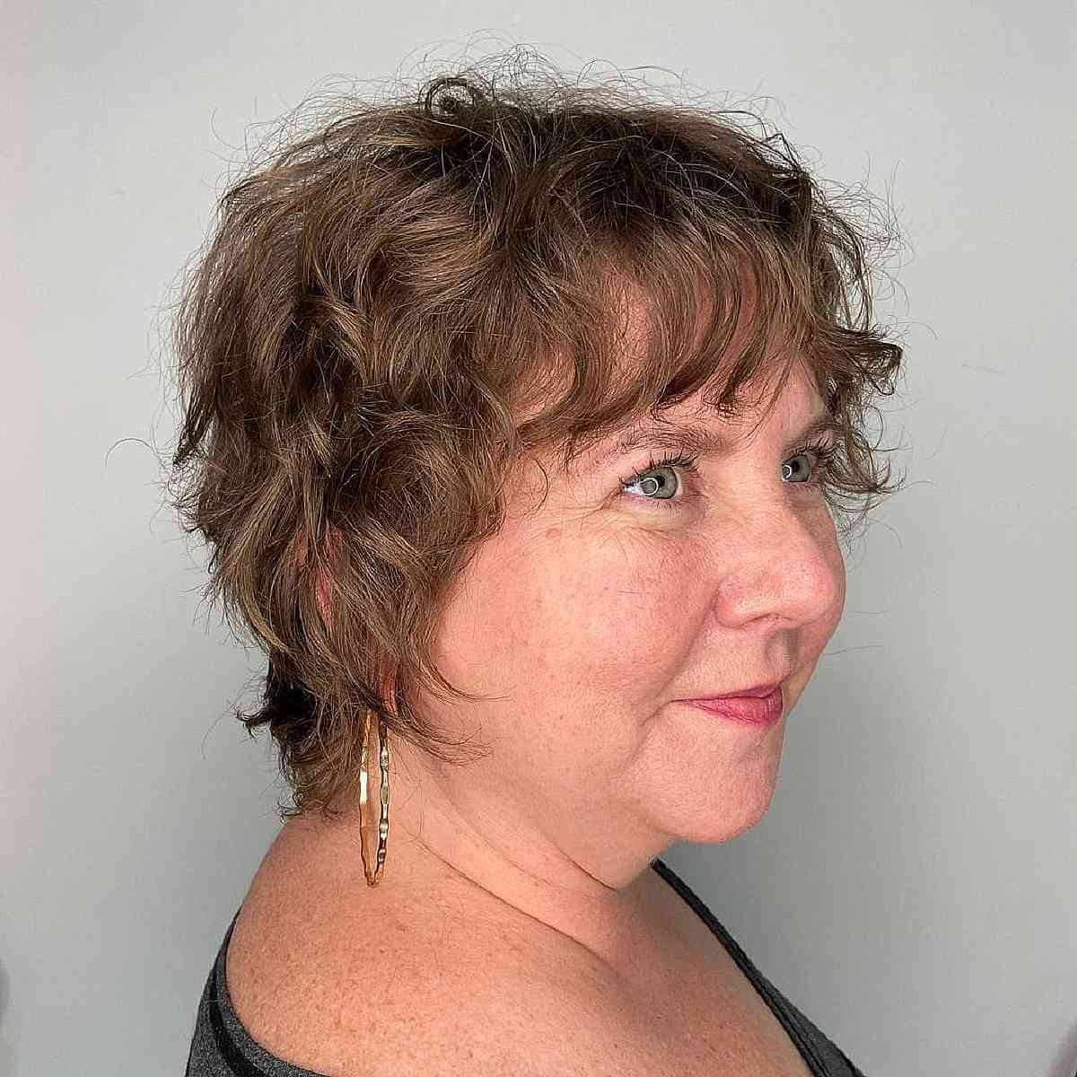 short wavy shag for ladies aged fifty with round faces