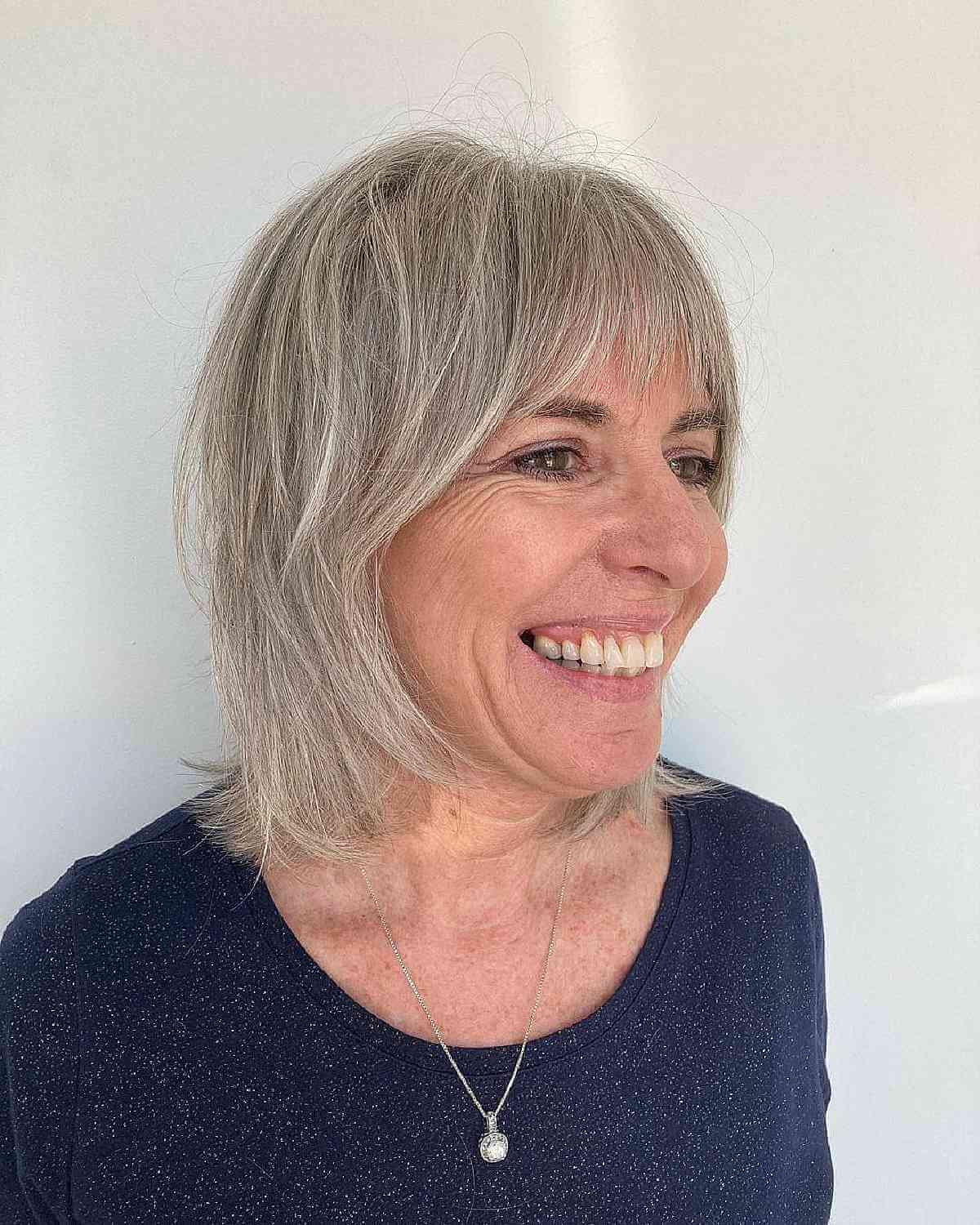 soft shag with curtain bangs for women in their 50s with straight hair