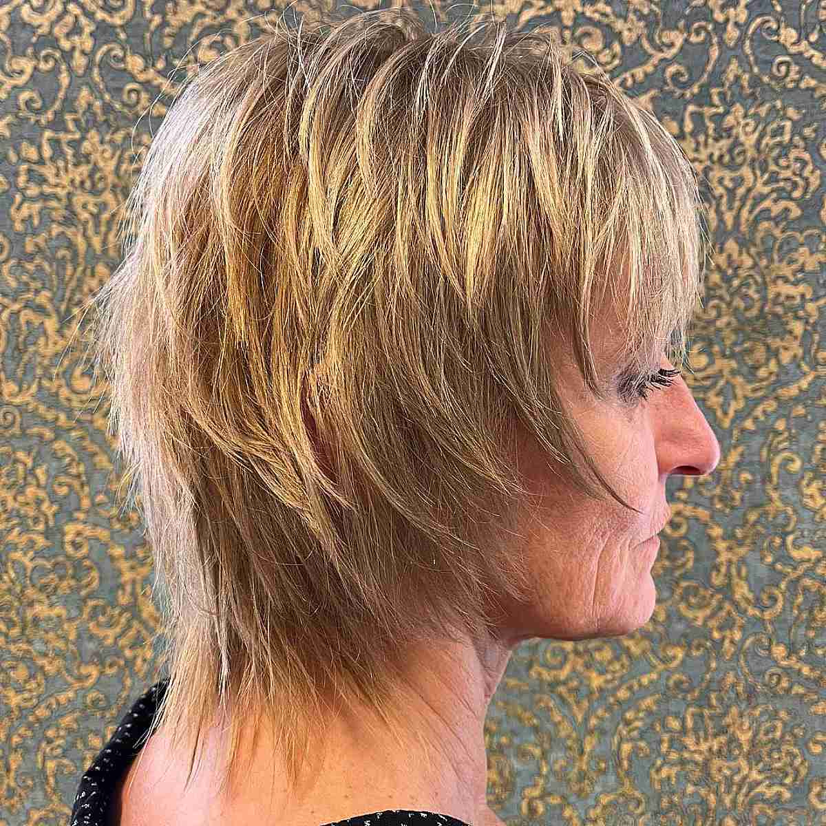 straight mullet shag with golden blonde color for a woman over 70