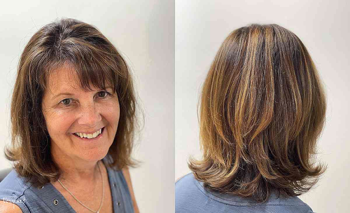 sun kissed medium layered cut with side bangs for ladies over 50