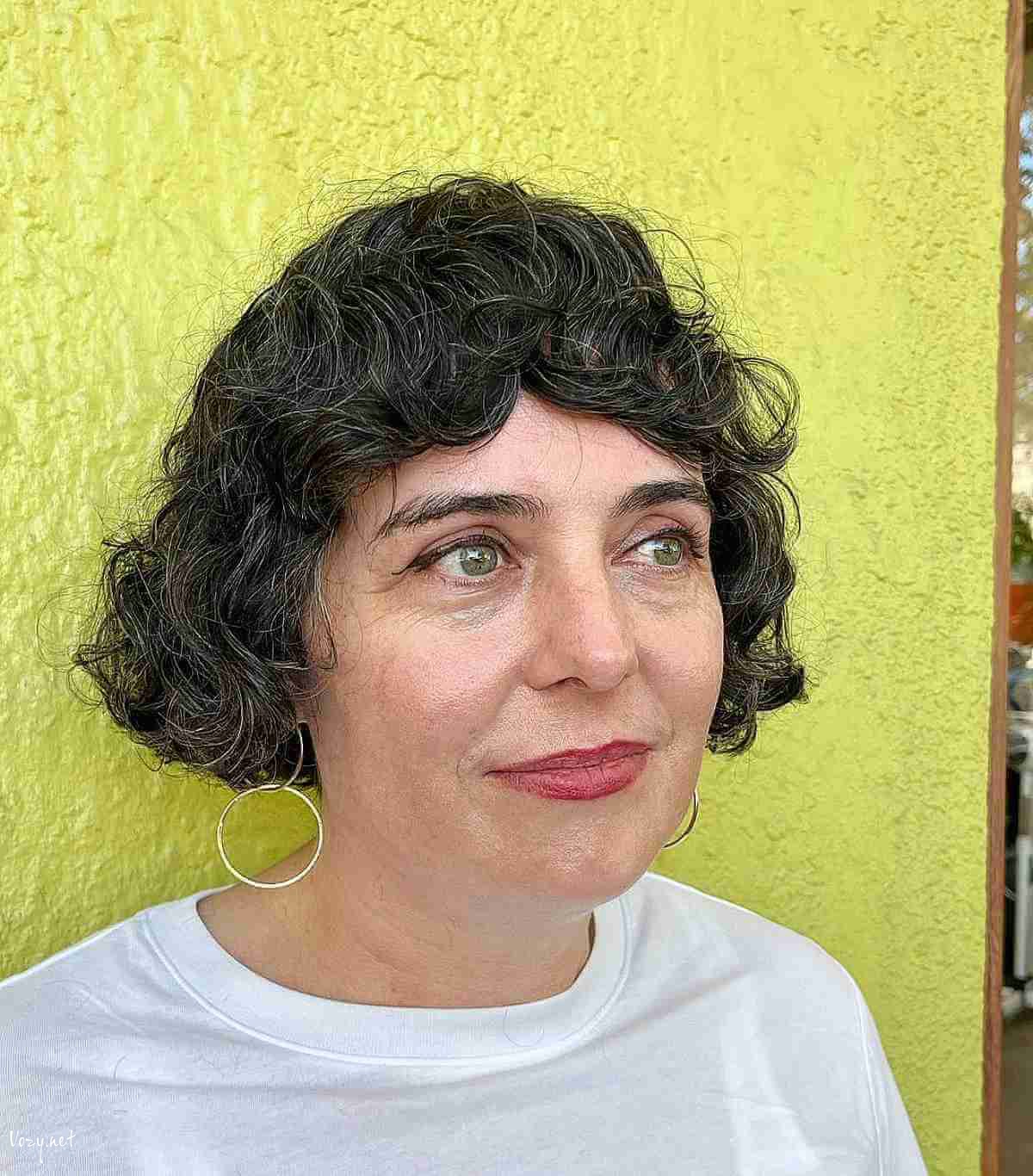 super short curly french bob with razored layers for women over 50