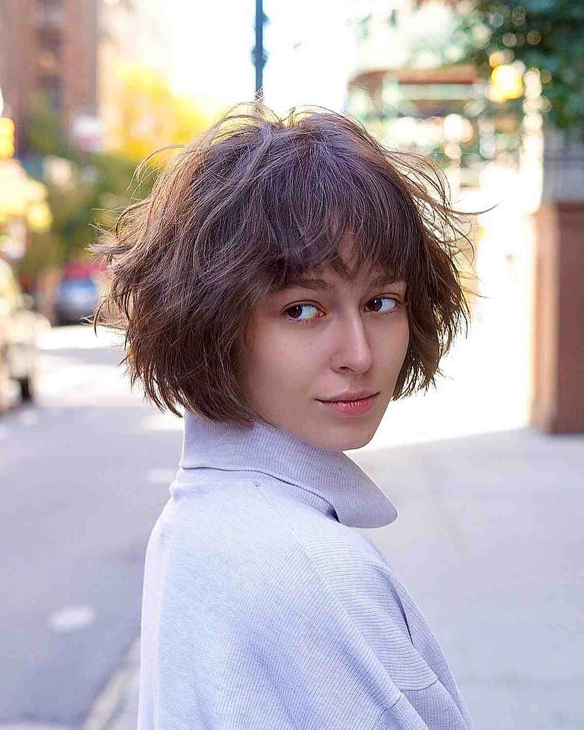 textured messy french bob cut with layers and bangs