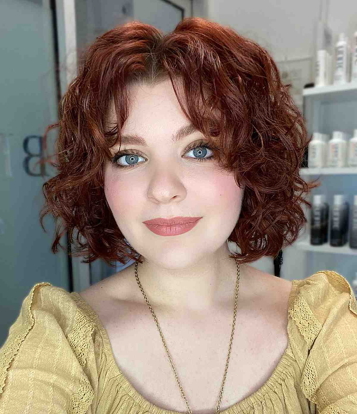 textured middle part short bobbed hair with natural curls