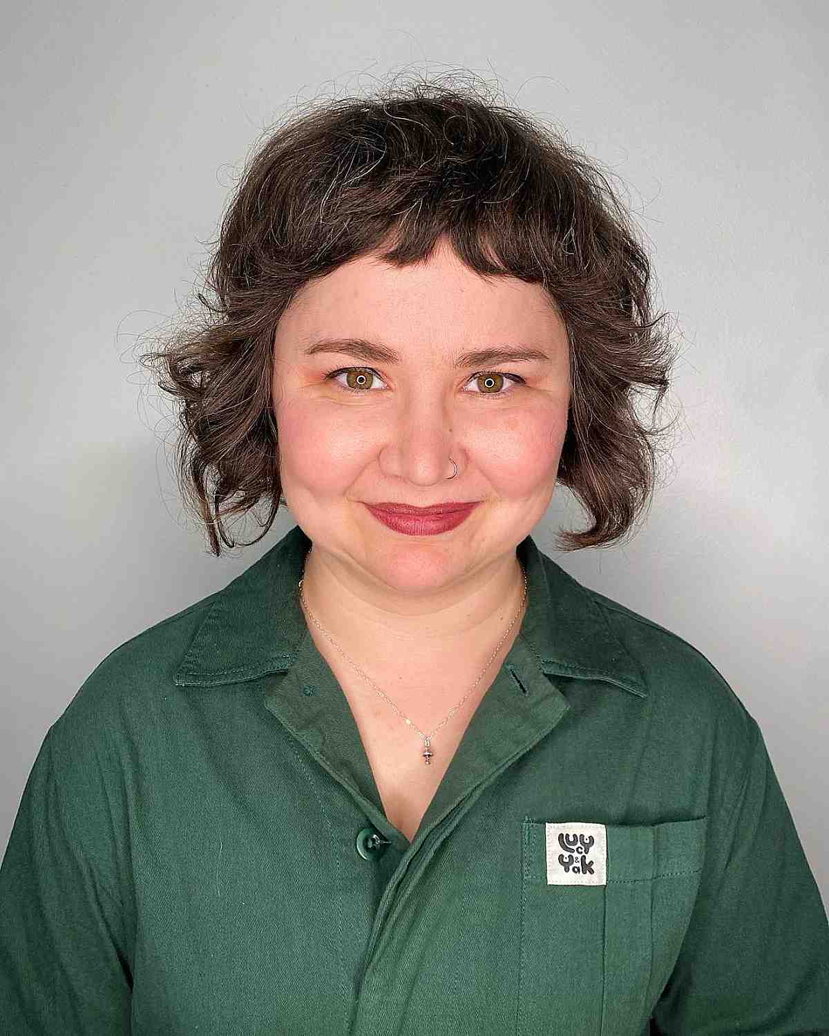 textured short bob with razored layers and baby bangs