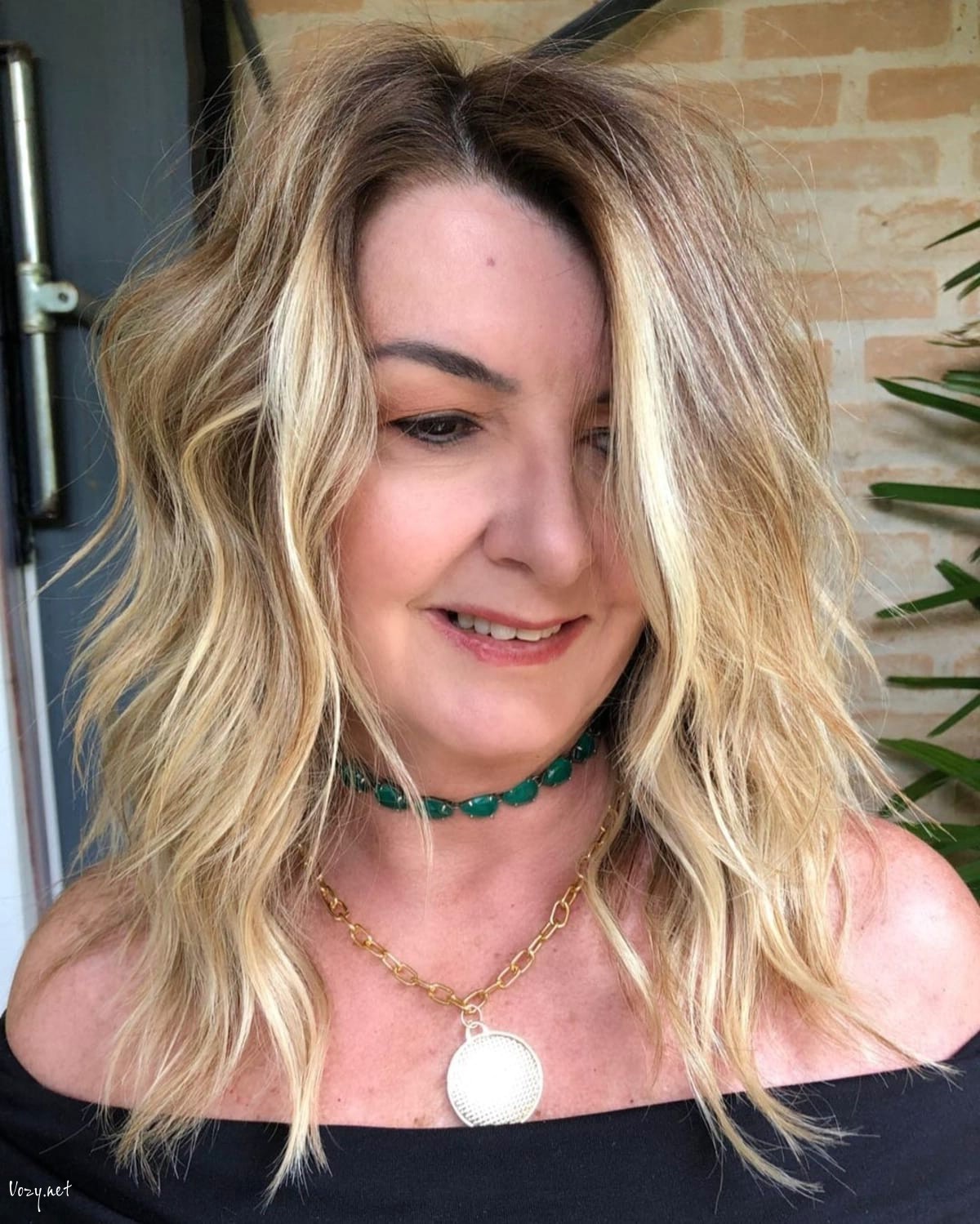 tousled shag for women over 50 with thick medium length hair