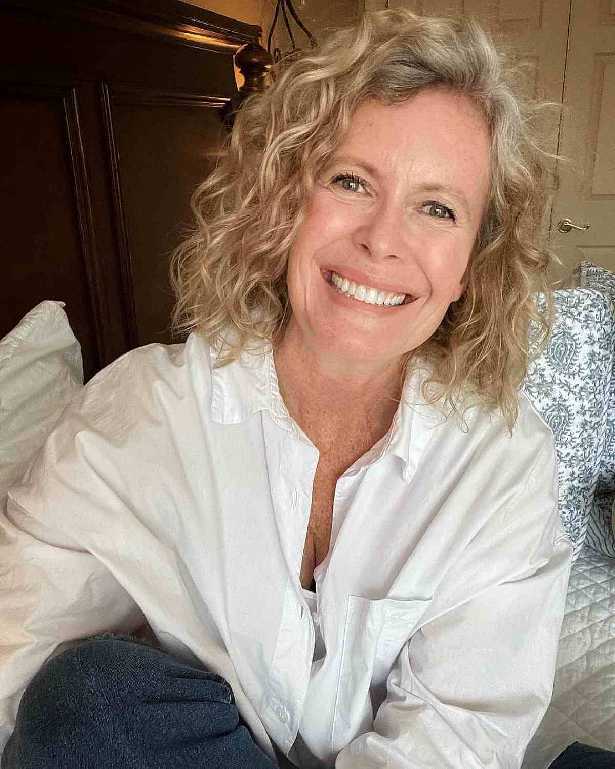 wash and wear medium length curls with a side part for ladies 50 and over 1