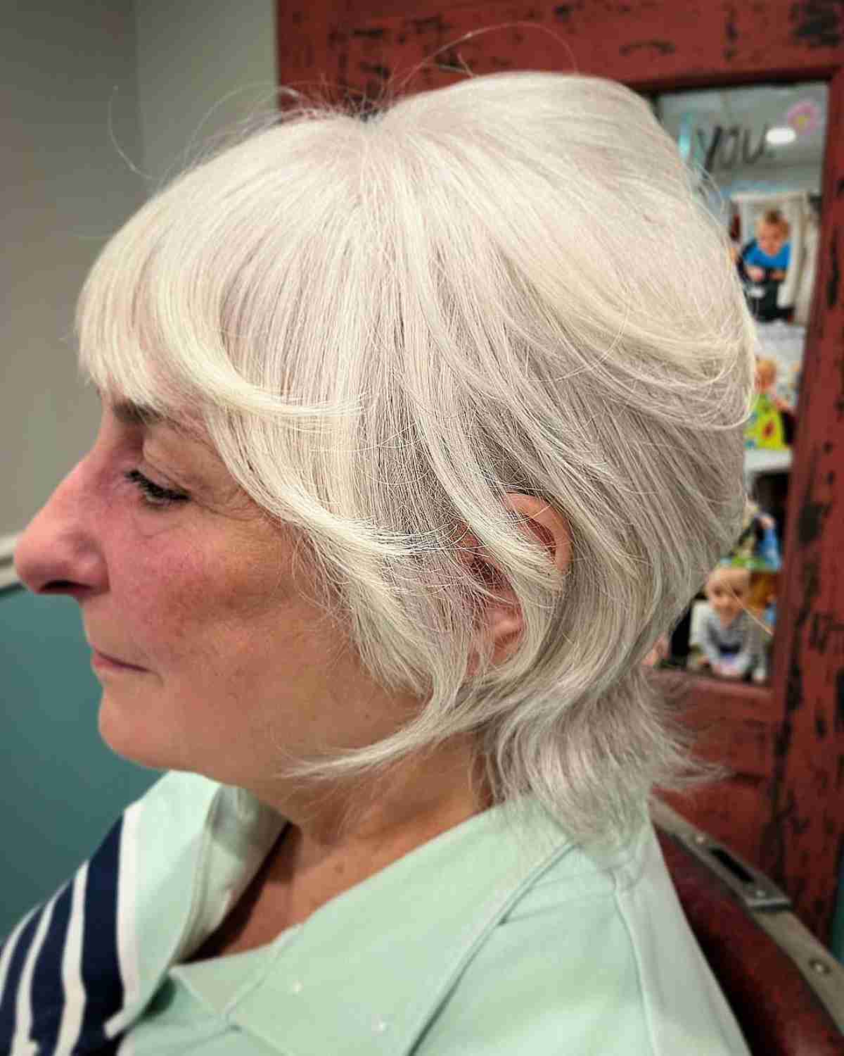 white shaggy wolf cut bob with face framing layers and bangs for 70 year olds