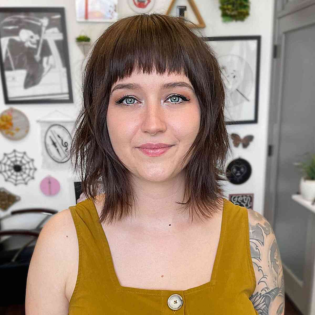 brunette long bob with bangs and choppy layers on women with rounder faces